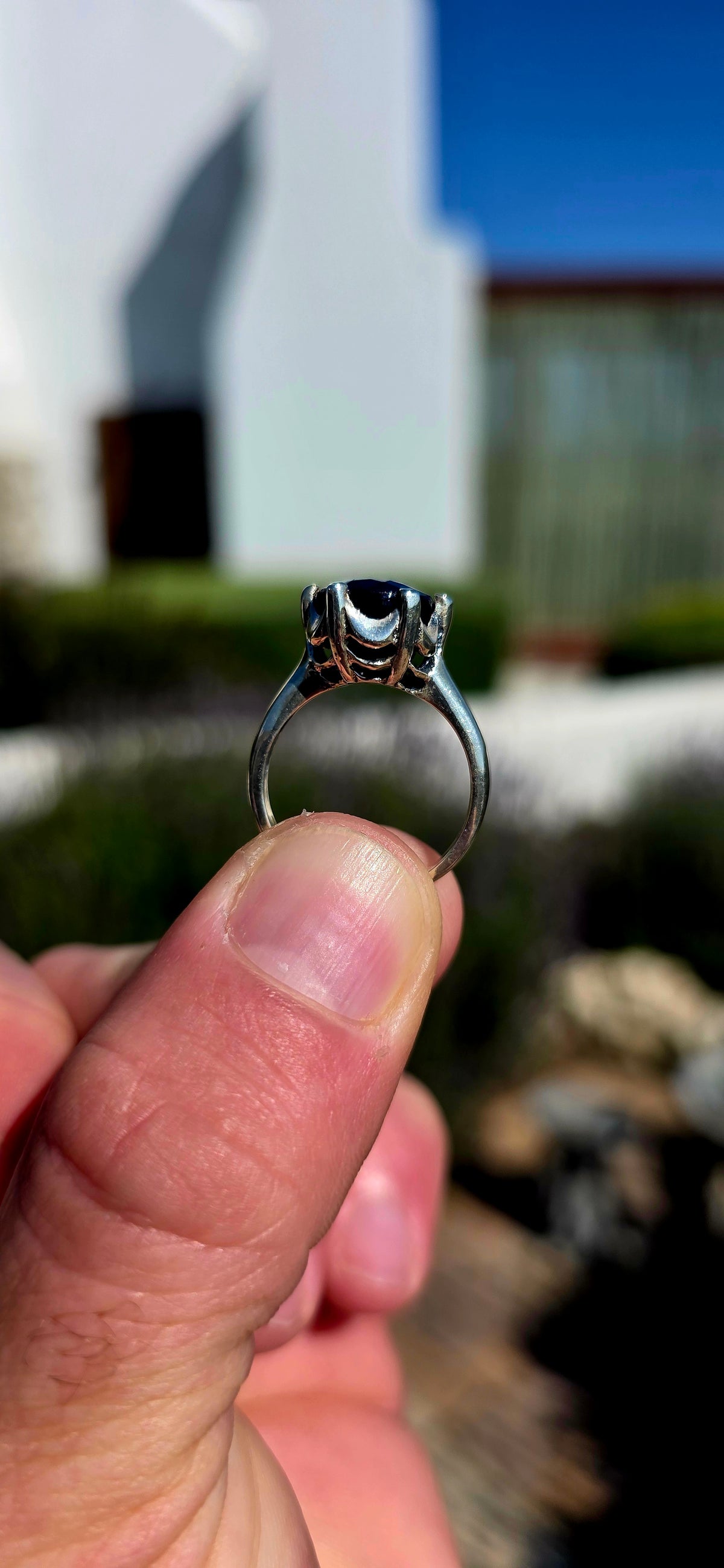 Most gorgeous sterling silver solitaire ring featuring a generously sized oval-cut sapphire in the most beautiful deep midnight-blue hue.
