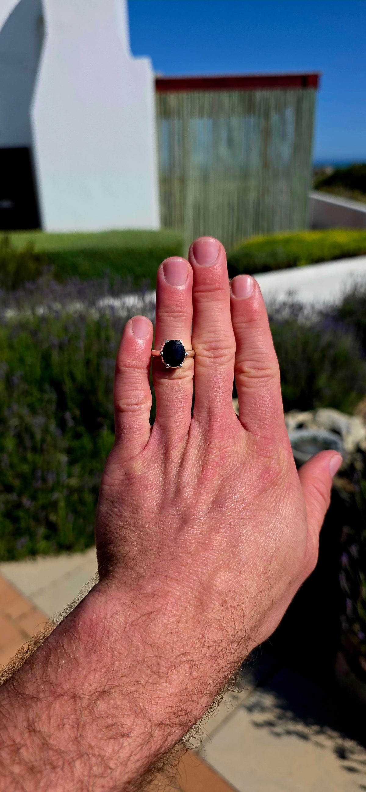 Most gorgeous sterling silver solitaire ring featuring a generously sized oval-cut sapphire in the most beautiful deep midnight-blue hue.