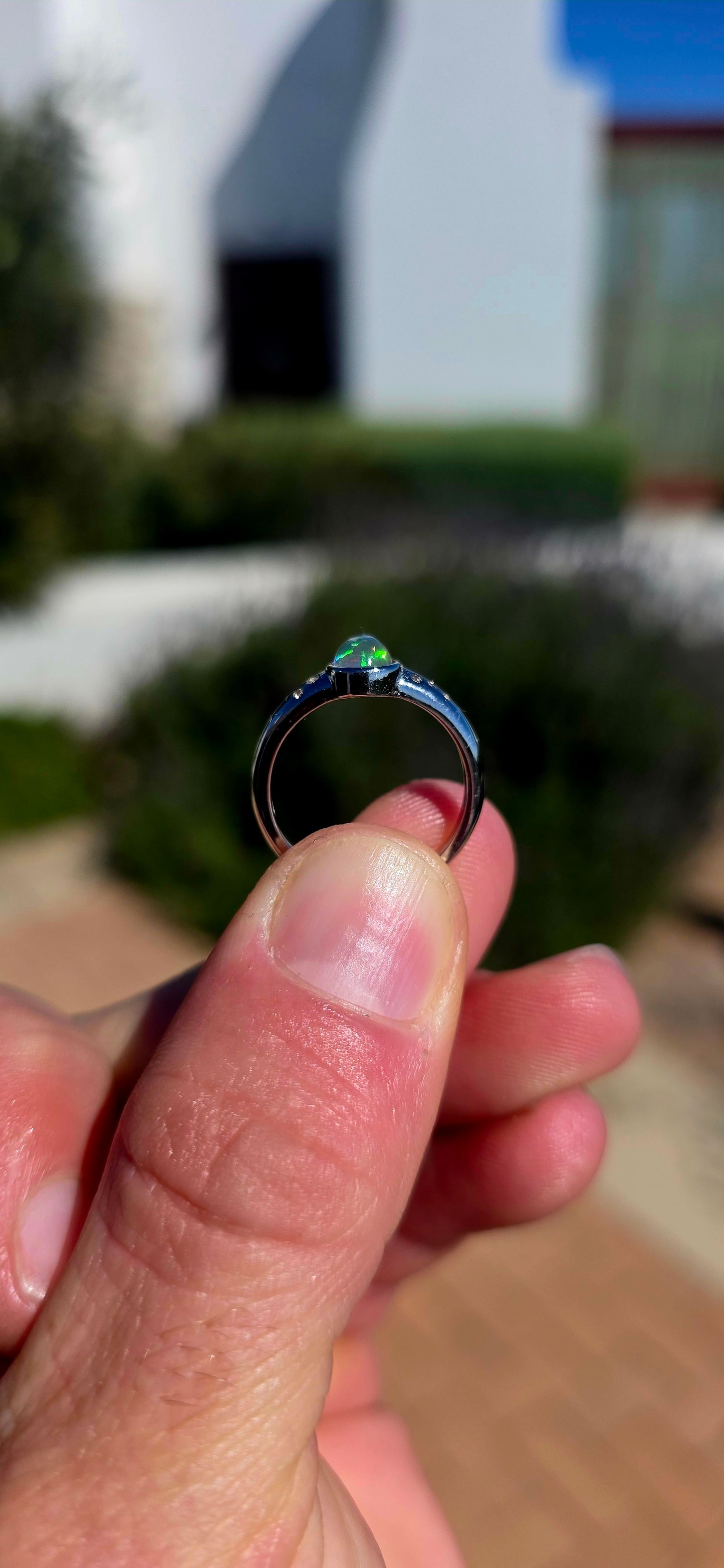 Pure little flashes of magic! This beautiful sterling silver solitaire-style ring centres around an oval Ethiopian Welo water opal cabochon, smoothly tube-set to really let that incredible natural play-of-colour take centre stage.