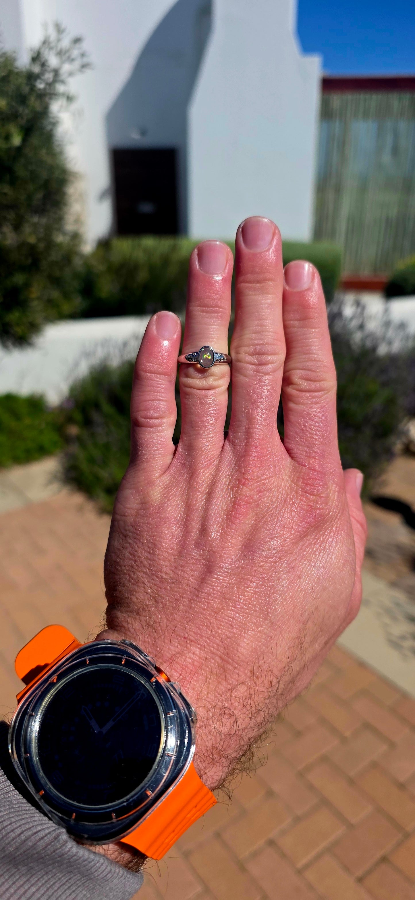 Pure little flashes of magic! This beautiful sterling silver solitaire-style ring centres around an oval Ethiopian Welo water opal cabochon, smoothly tube-set to really let that incredible natural play-of-colour take centre stage.