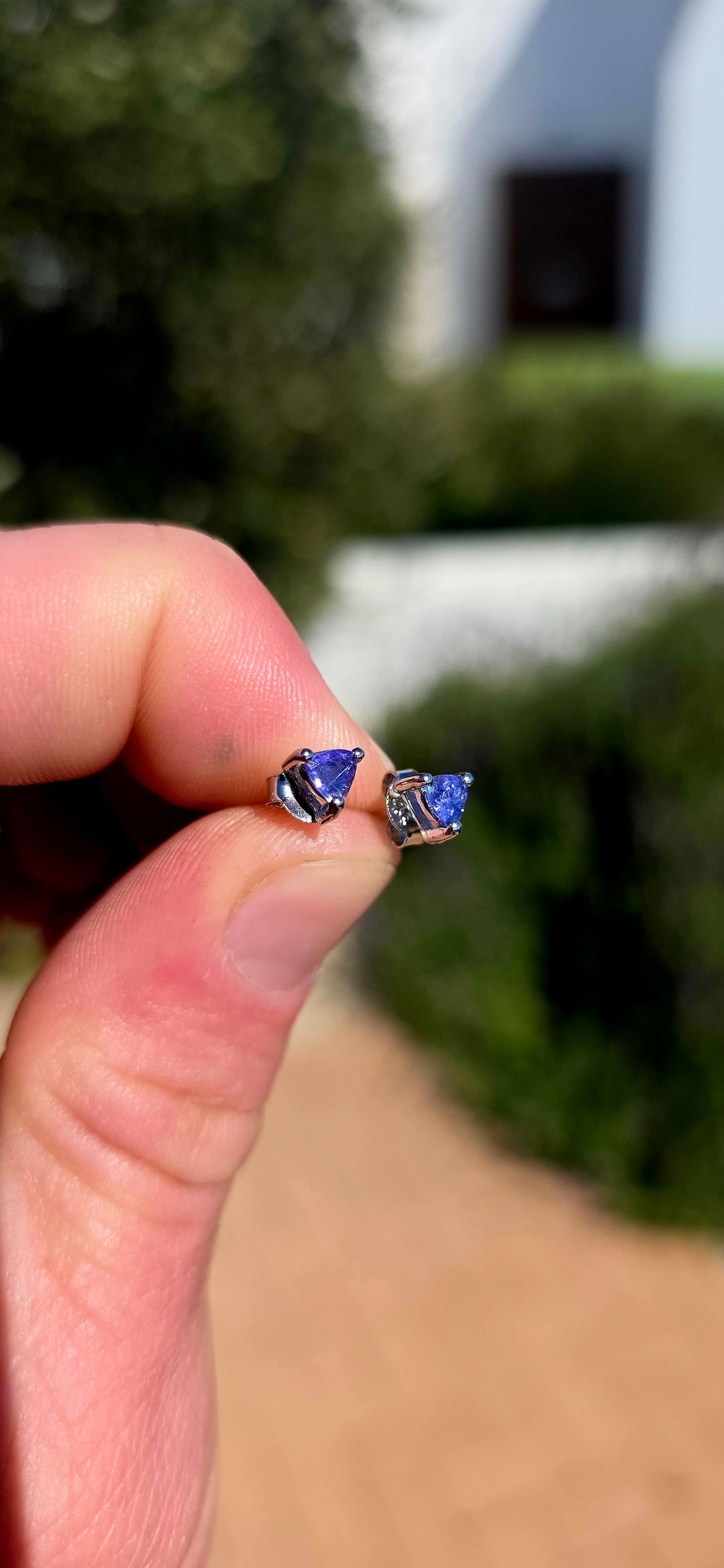 Small but seriously striking! These gorgeous sterling silver stud earrings each feature a sparkling natural tanzanite, beautifully faceted into a modern trillion cut and securely held in a classic three-prong setting.