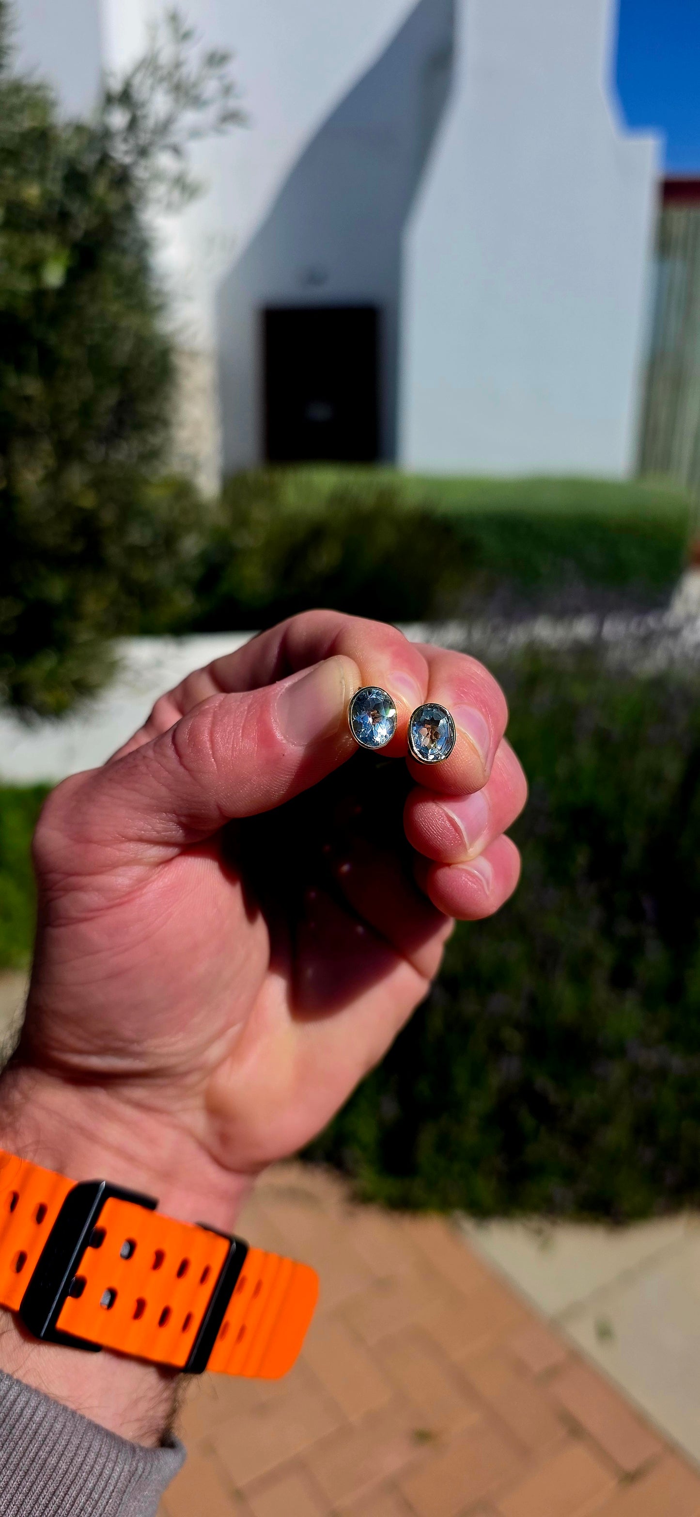 Clean, classic and all about that gorgeous pop of blue! .These beautifully made sterling silver and 18ct yellow gold stud earrings each feature a generously sized oval-cut natural sky blue topaz, beautifully faceted to catch the light from every angle.