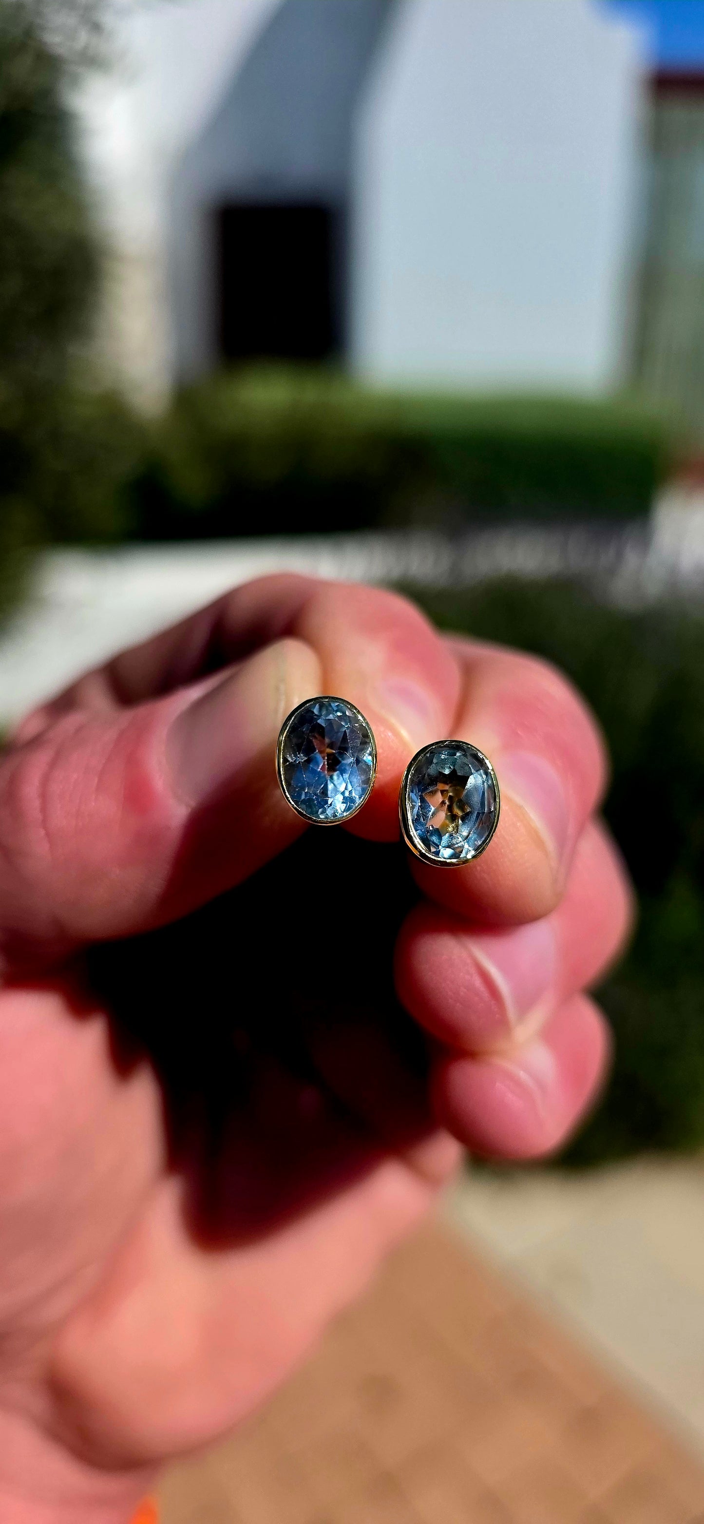 Clean, classic and all about that gorgeous pop of blue! .These beautifully made sterling silver and 18ct yellow gold stud earrings each feature a generously sized oval-cut natural sky blue topaz, beautifully faceted to catch the light from every angle.
