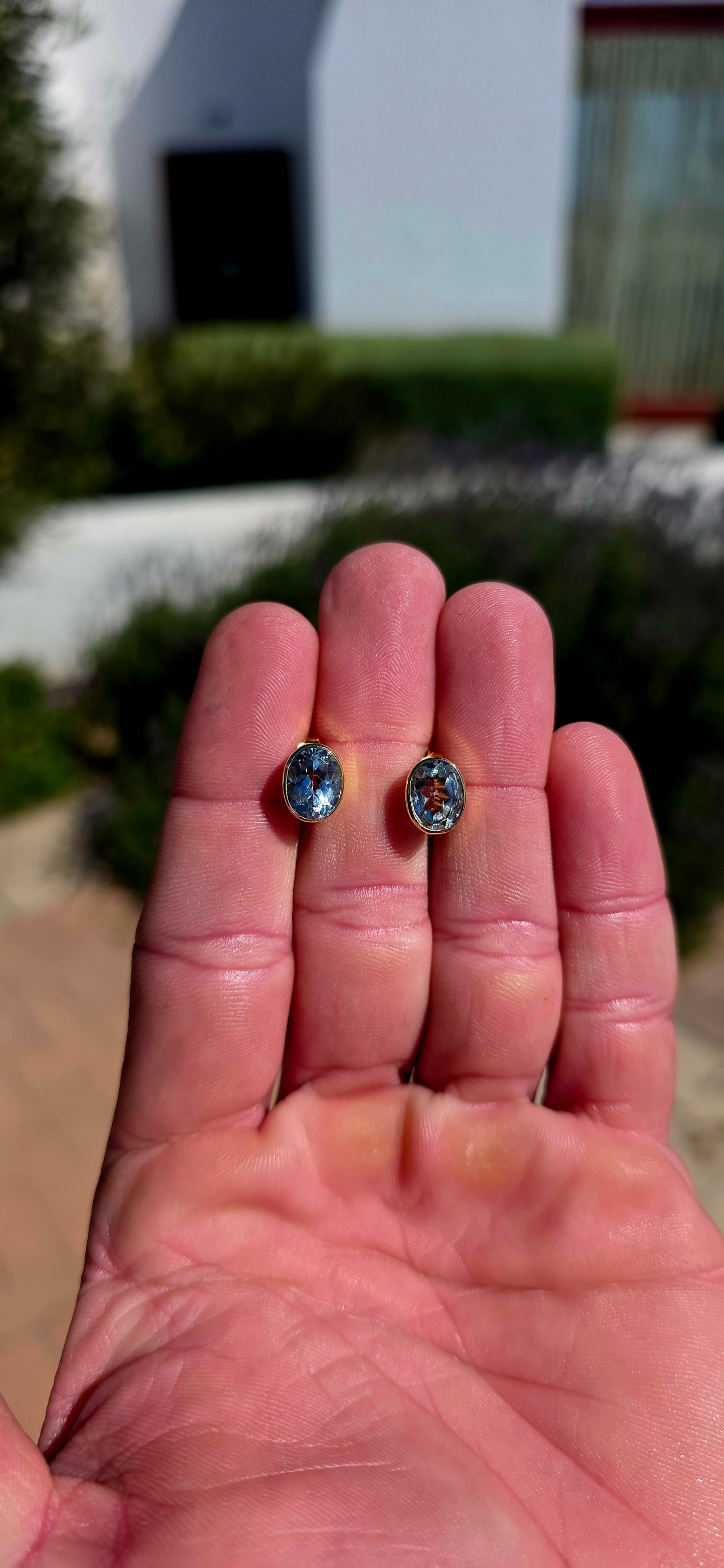 Clean, classic and all about that gorgeous pop of blue! .These beautifully made sterling silver and 18ct yellow gold stud earrings each feature a generously sized oval-cut natural sky blue topaz, beautifully faceted to catch the light from every angle.