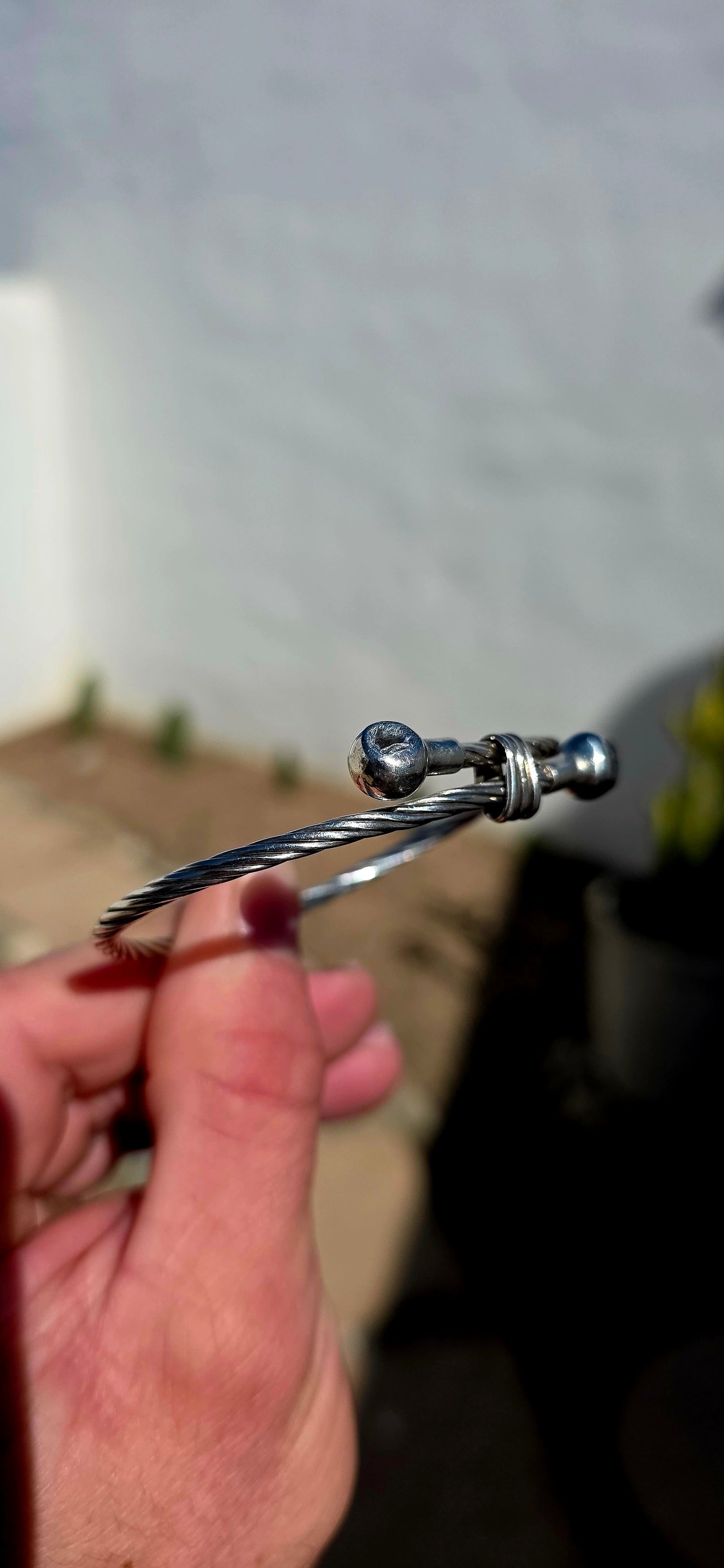 Simple, chunky and UNISEX! This vintage sterling silver bracelet features a fabulous twisted cable-style band, wrapping around the wrist and finished with two polished spherical terminals.