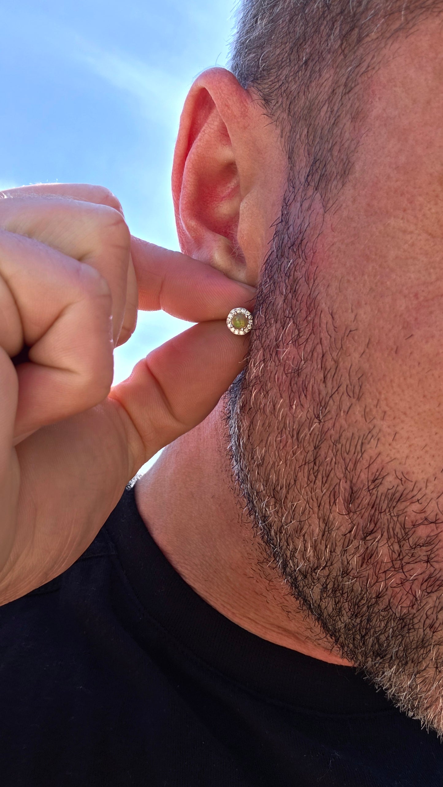Small but absolutely magical! These beautiful stud earrings are crafted in solid sterling silver, each centred with a round natural Ethiopian opal cabochon, securely prong-set and surrounded by a delicate halo of sparkling CZ gemstones.