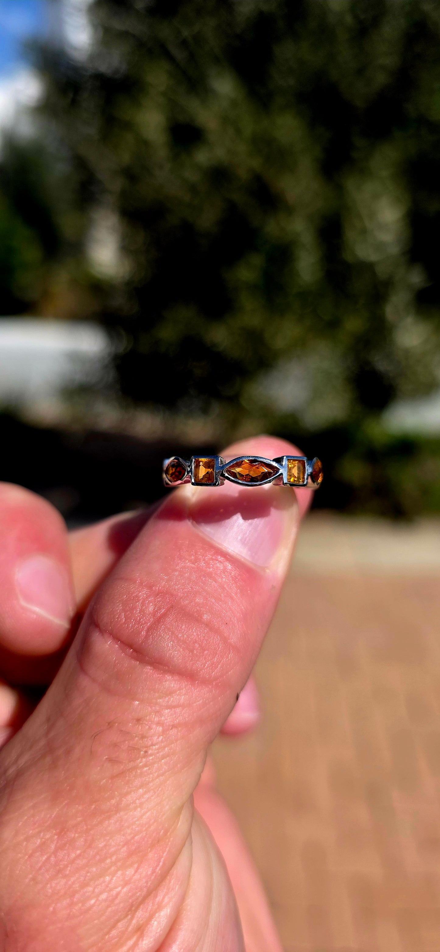 What a fabulous burst of sunshine! This beautiful sterling silver half-eternity ring is tube-set with alternating citrine gemstones, combining princess and marquise cuts in gorgeous shades of golden yellow, honey and deep burnt orange.