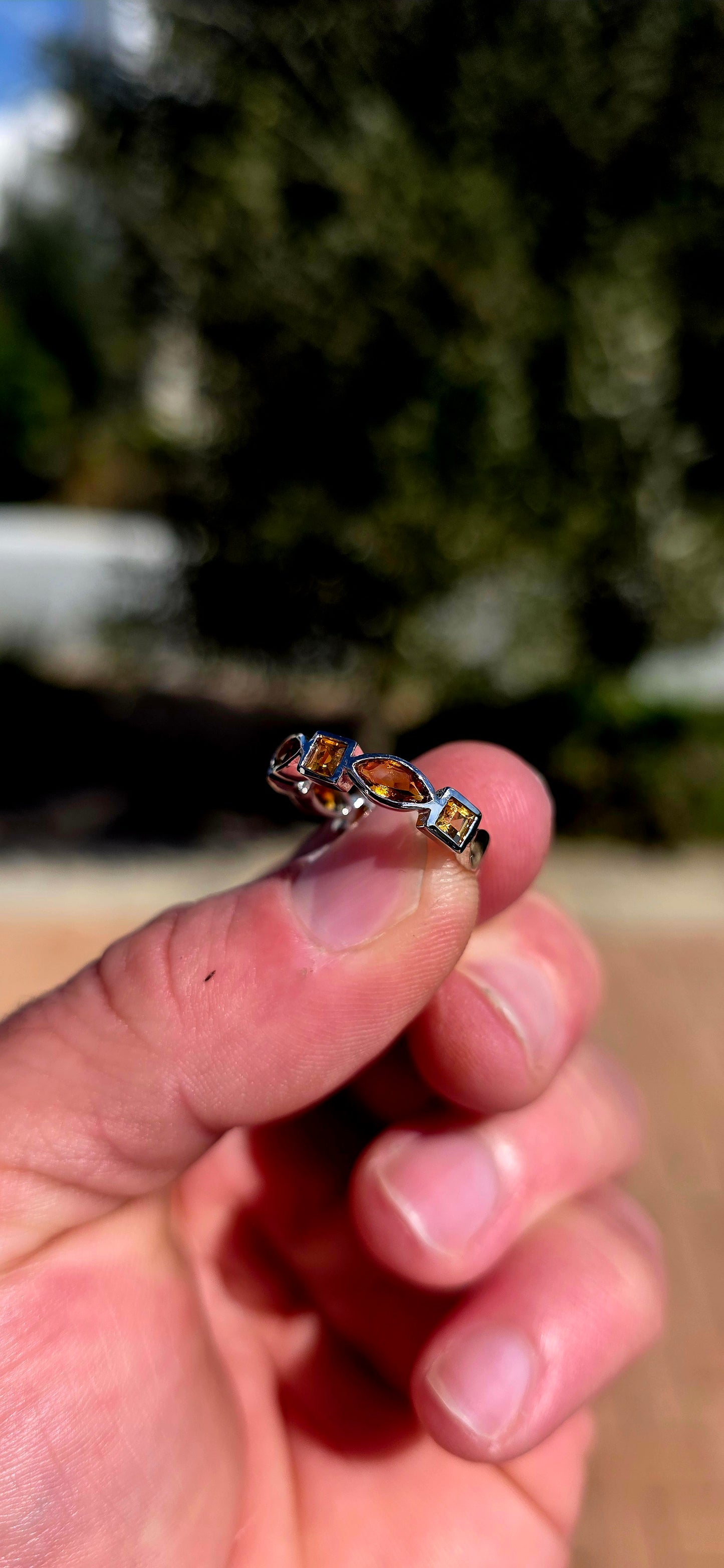 What a fabulous burst of sunshine! This beautiful sterling silver half-eternity ring is tube-set with alternating citrine gemstones, combining princess and marquise cuts in gorgeous shades of golden yellow, honey and deep burnt orange.
