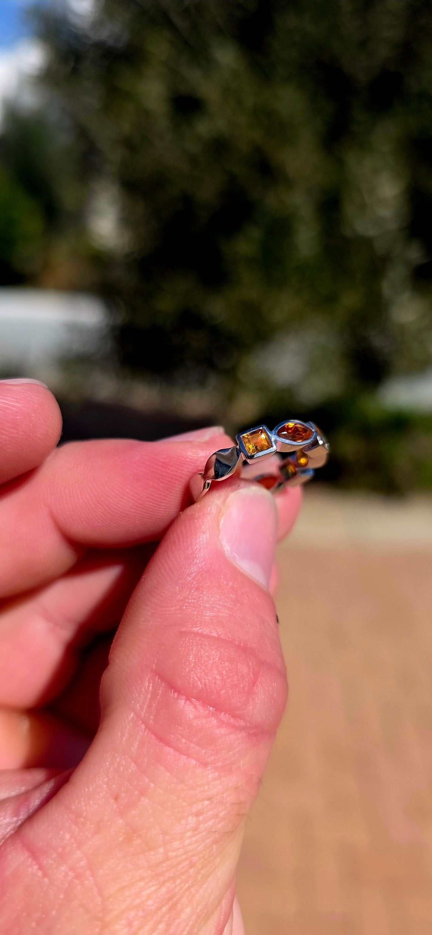 What a fabulous burst of sunshine! This beautiful sterling silver half-eternity ring is tube-set with alternating citrine gemstones, combining princess and marquise cuts in gorgeous shades of golden yellow, honey and deep burnt orange.