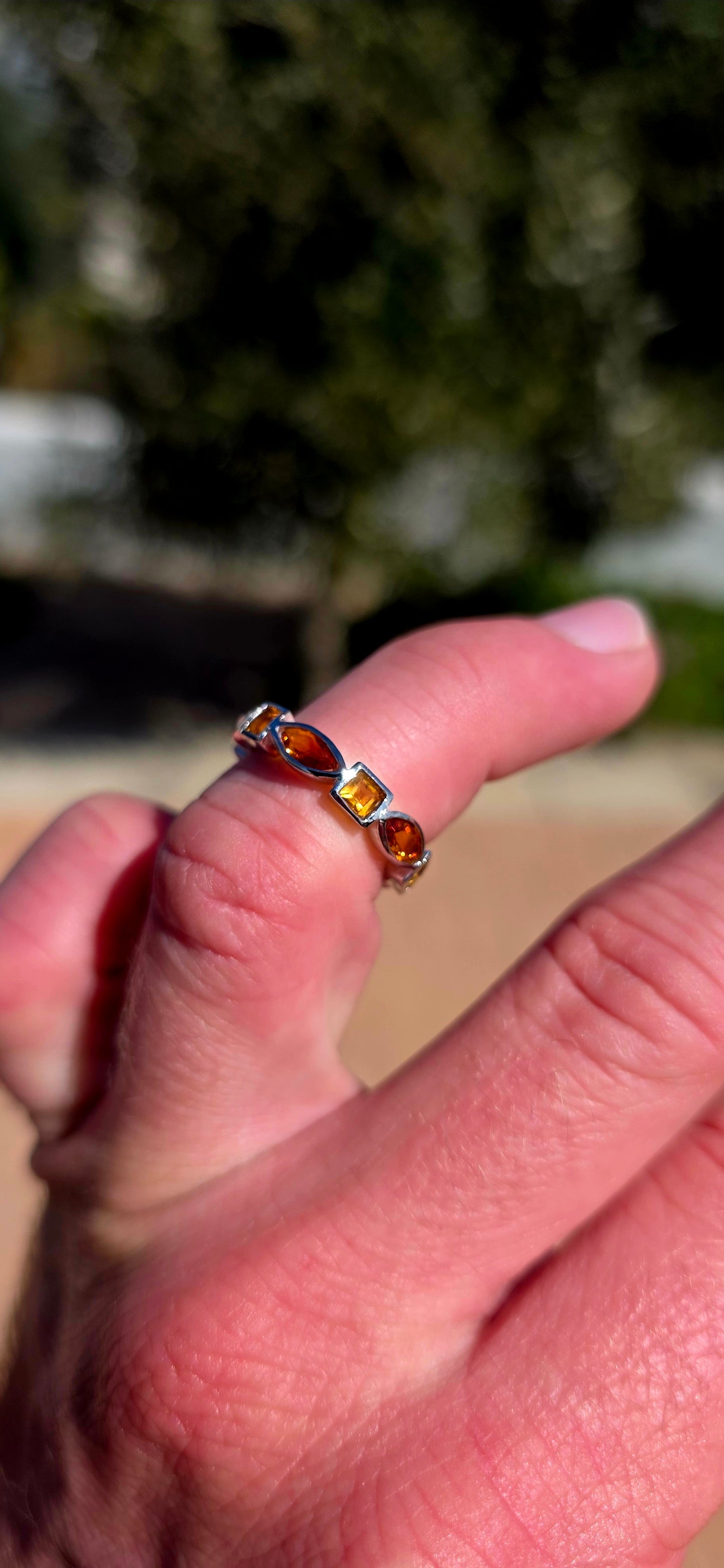 What a fabulous burst of sunshine! This beautiful sterling silver half-eternity ring is tube-set with alternating citrine gemstones, combining princess and marquise cuts in gorgeous shades of golden yellow, honey and deep burnt orange.