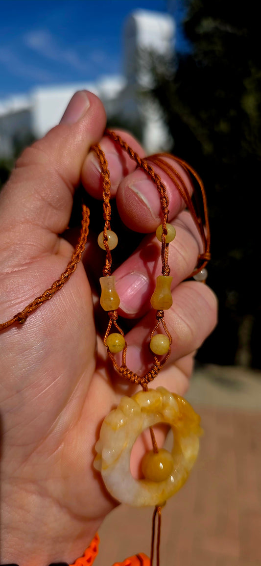 Beautifully earthy and wonderfully unusual! This vintage Oriental jade necklace is strung entirely by hand on warm bronze-brown macramé cord and features a gorgeous combination of creamy white and golden-yellow jade tones.