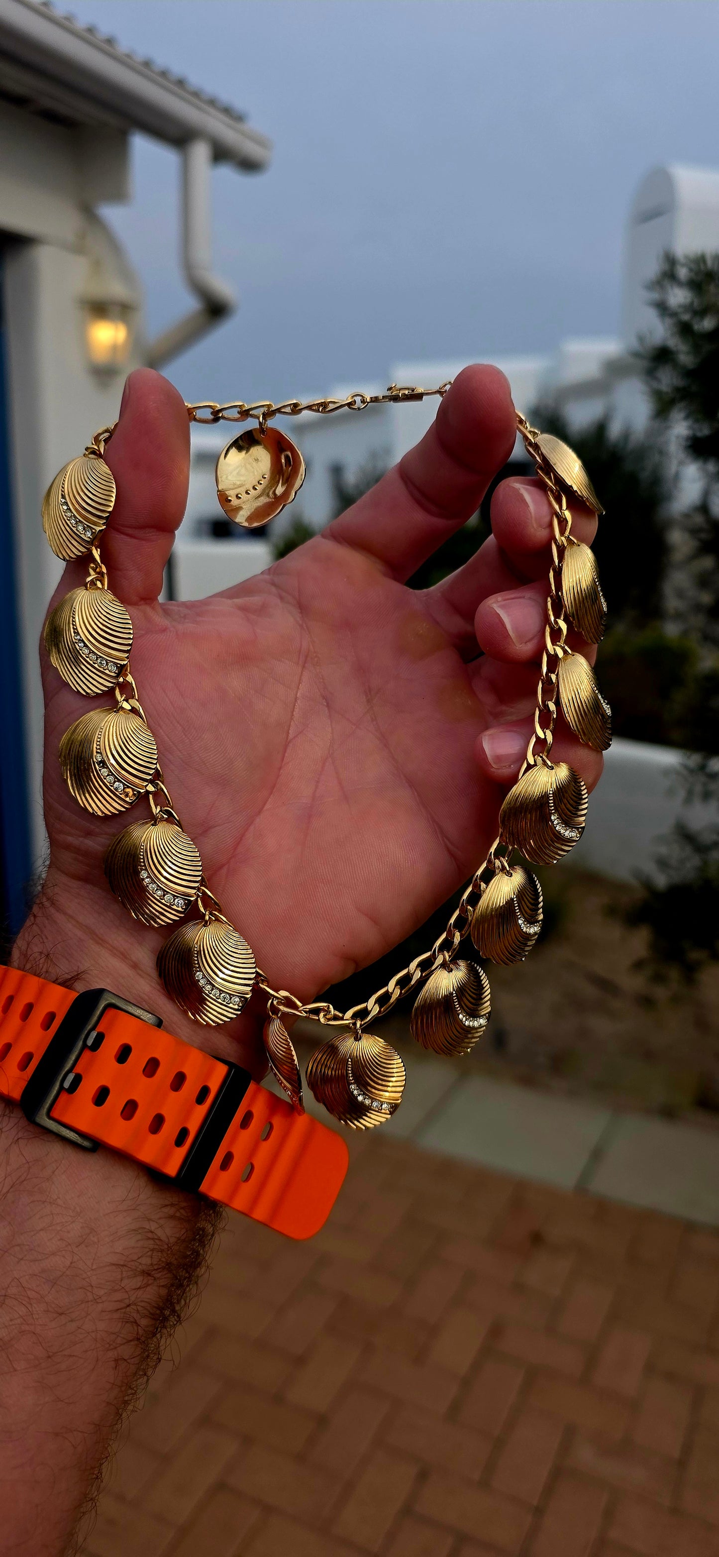 Dating to the 1980s, this striking vintage necklace by D-i-o-r is beautifully crafted in rich gold-plated metal and features an elongated curb-link chain dripping with 15 wonderfully dimensional shell charms.