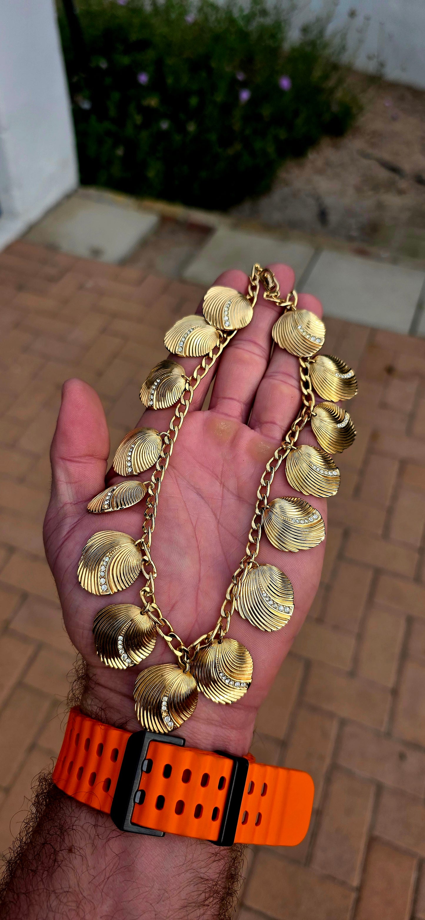 Dating to the 1980s, this striking vintage necklace by D-i-o-r is beautifully crafted in rich gold-plated metal and features an elongated curb-link chain dripping with 15 wonderfully dimensional shell charms.