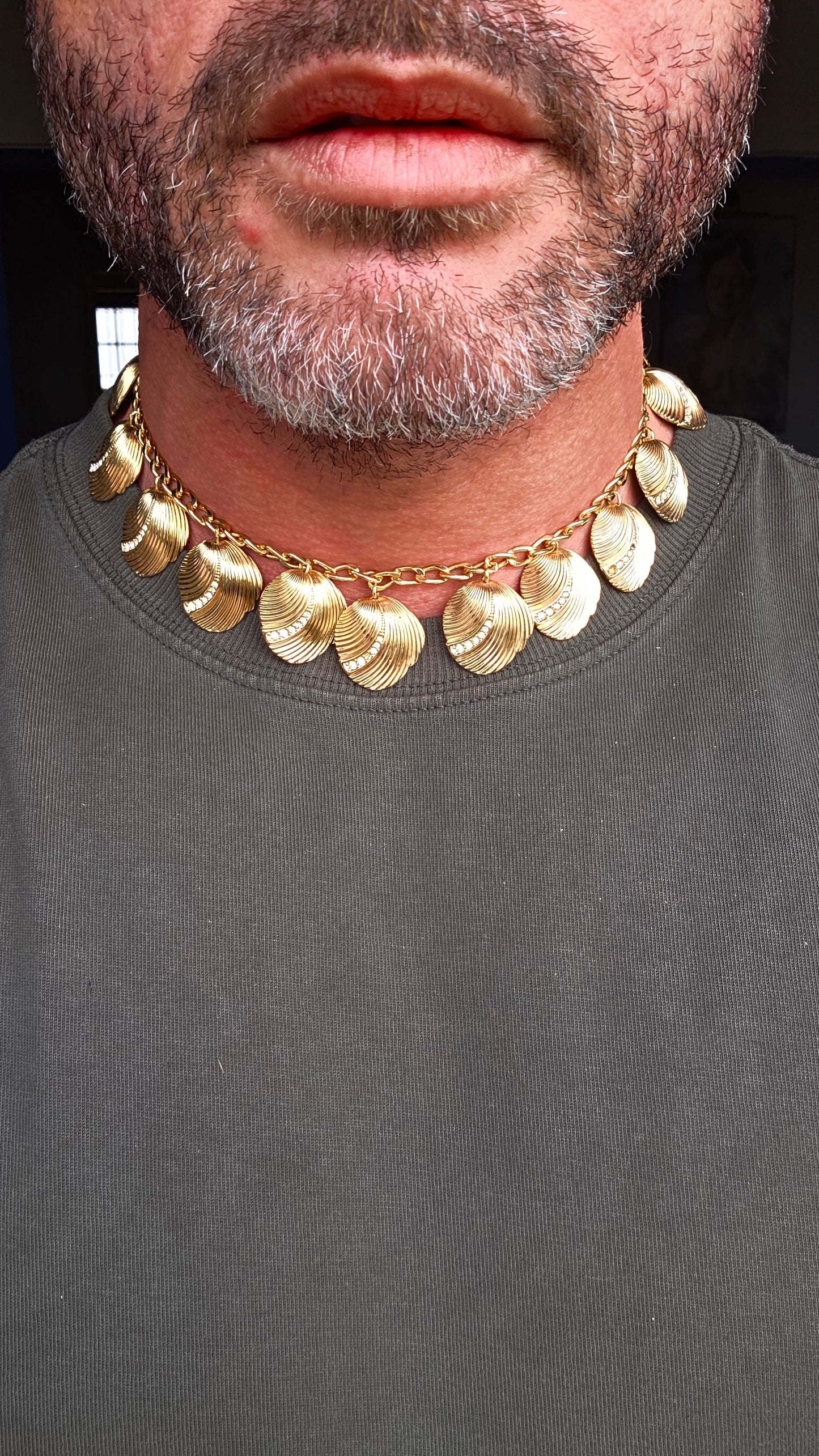 Dating to the 1980s, this striking vintage necklace by D-i-o-r is beautifully crafted in rich gold-plated metal and features an elongated curb-link chain dripping with 15 wonderfully dimensional shell charms.