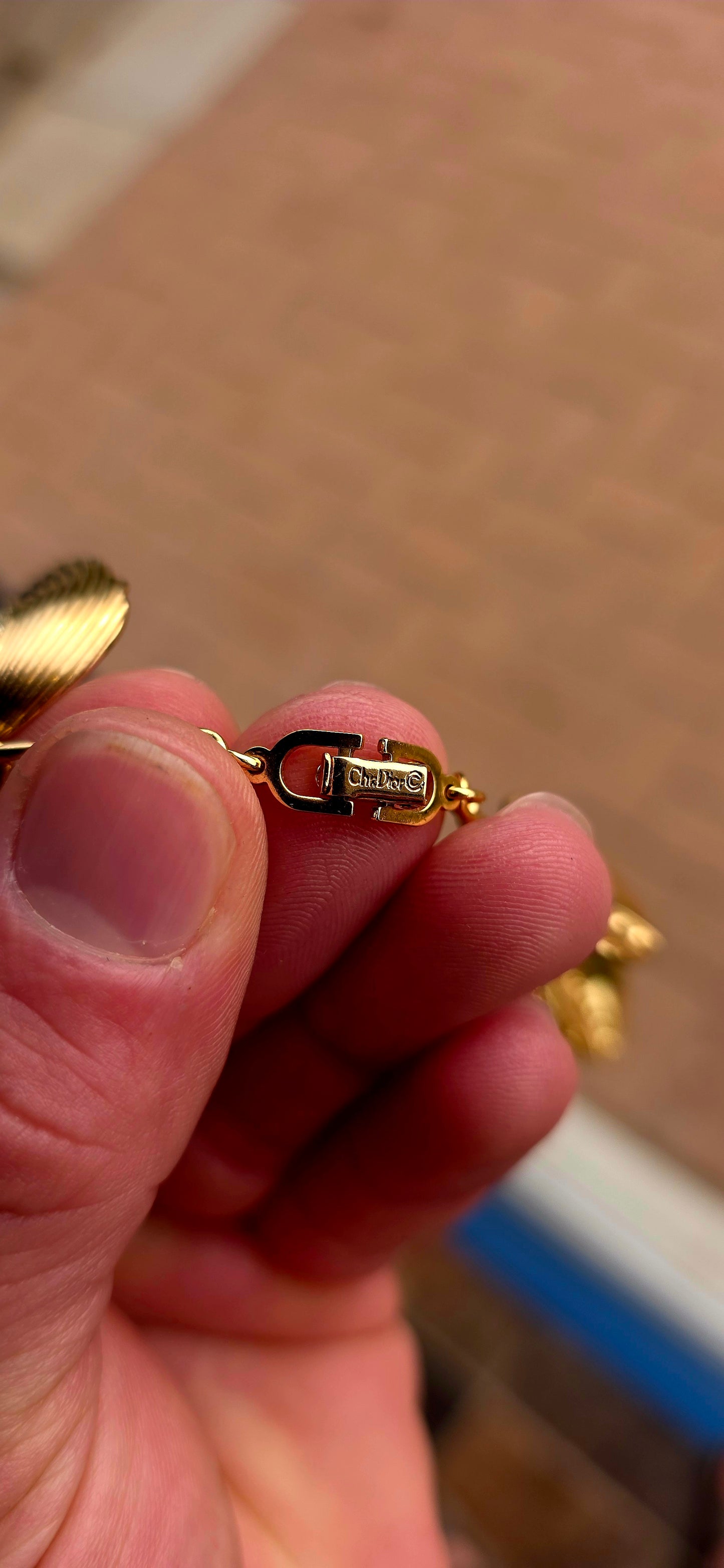 Dating to the 1980s, this striking vintage necklace by D-i-o-r is beautifully crafted in rich gold-plated metal and features an elongated curb-link chain dripping with 15 wonderfully dimensional shell charms.