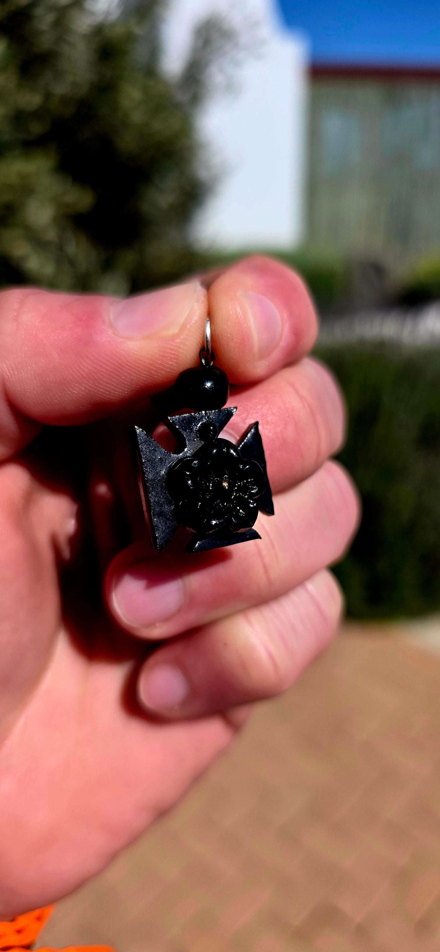 A wonderfully unusual little survivor from the Victorian era — an antique hand-carved Whitby jet pendant/charm, beautifully fashioned into the distinctive form of a Maltese cross.