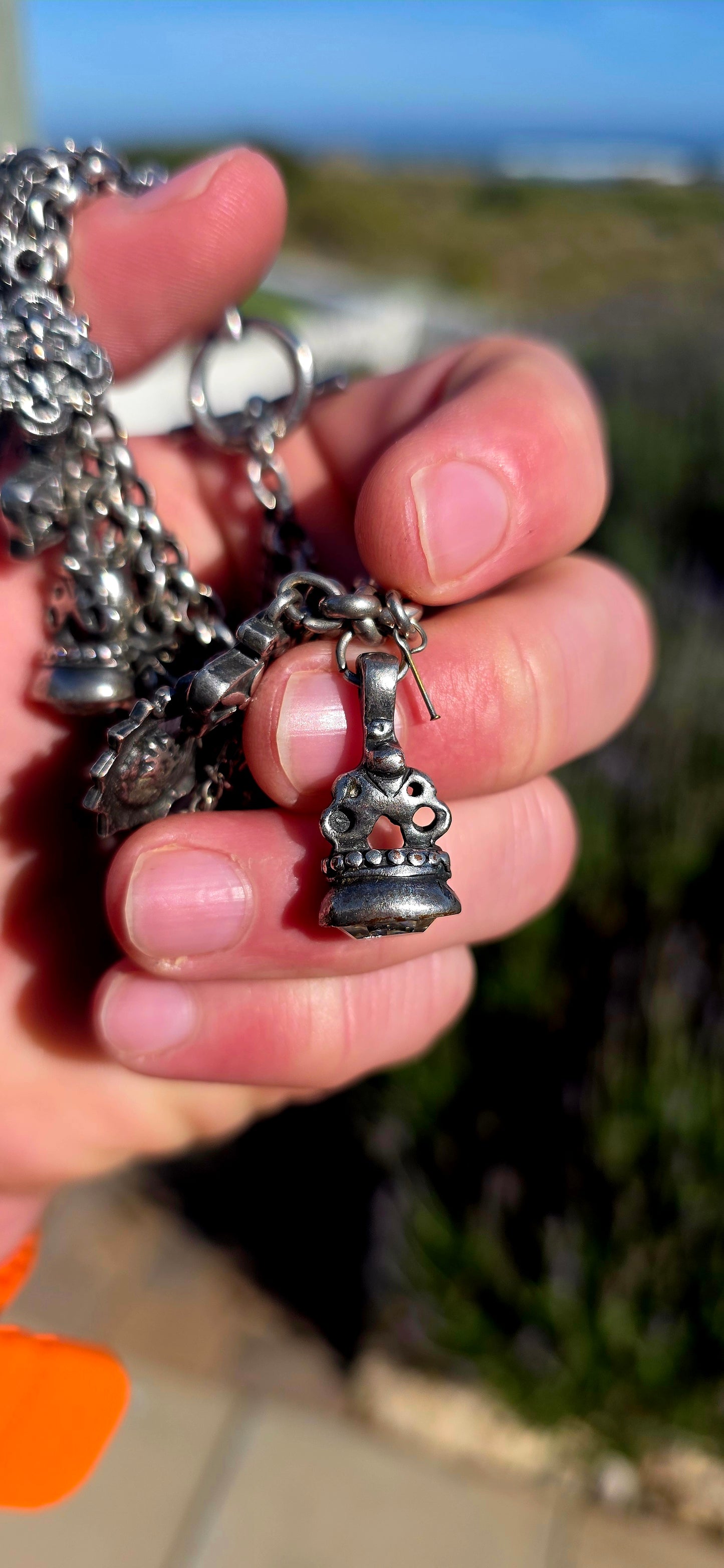 More is MORE! A fabulous chunky designer costume charm bracelet by Miglio, crafted in silver-plated metal and absolutely loaded with an eclectic collection of antique-inspired charms.