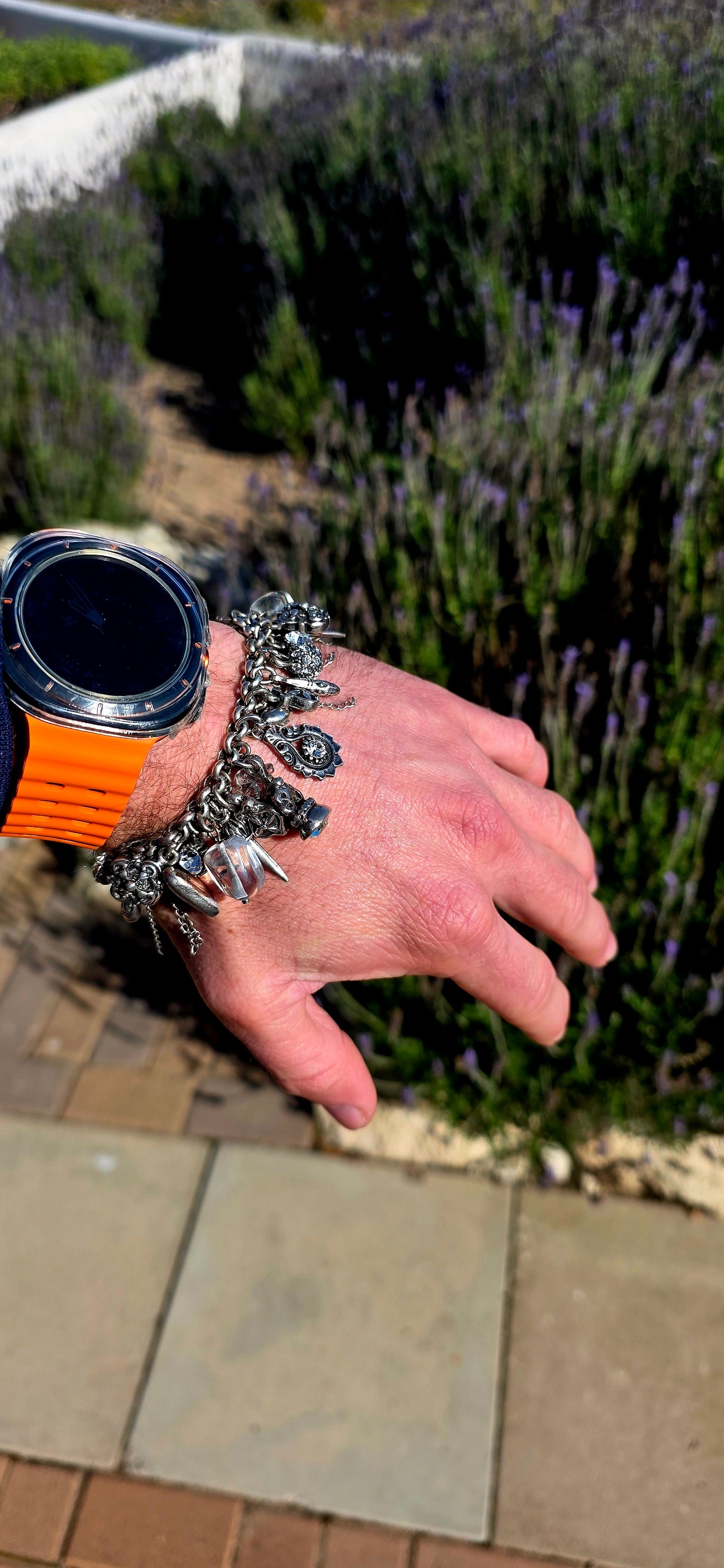 More is MORE! A fabulous chunky designer costume charm bracelet by Miglio, crafted in silver-plated metal and absolutely loaded with an eclectic collection of antique-inspired charms.