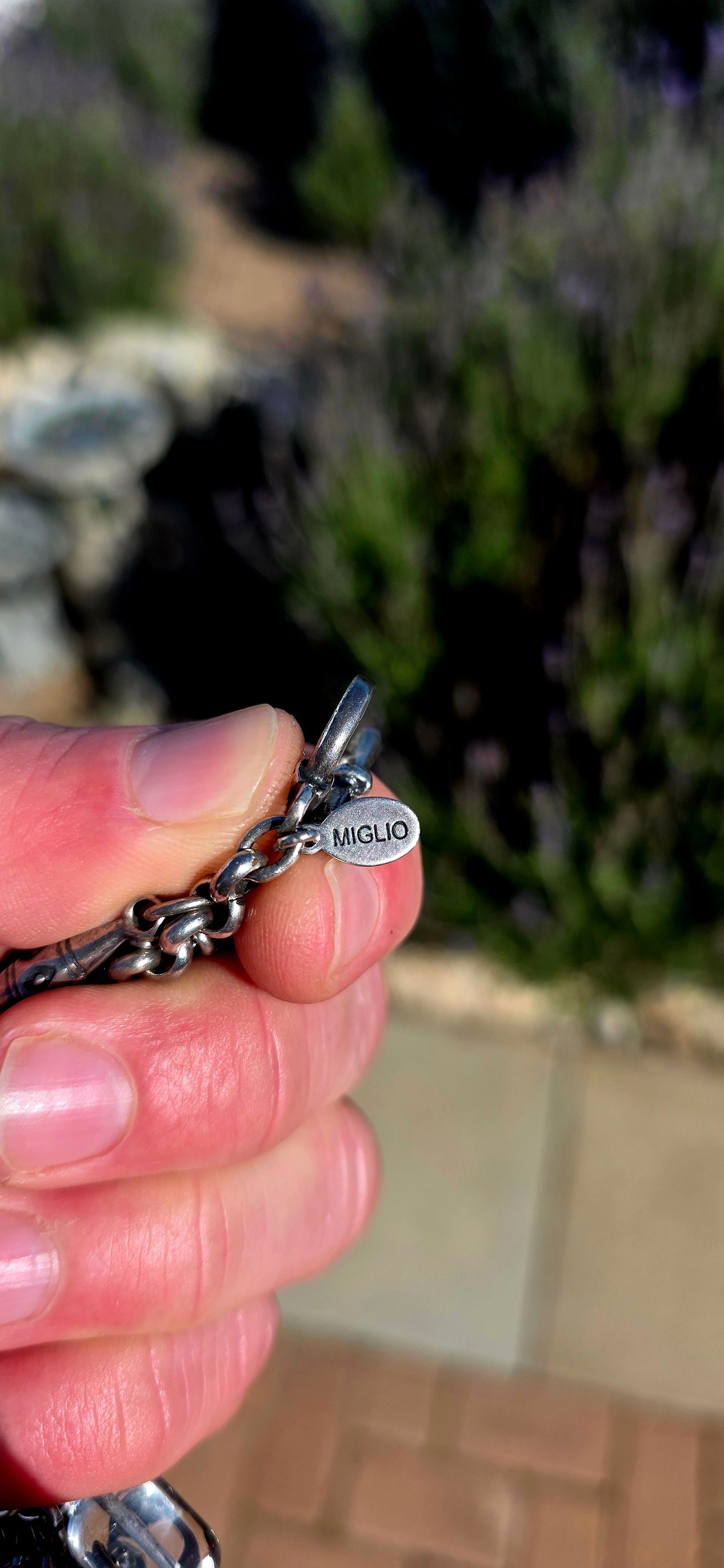 More is MORE! A fabulous chunky designer costume charm bracelet by Miglio, crafted in silver-plated metal and absolutely loaded with an eclectic collection of antique-inspired charms.