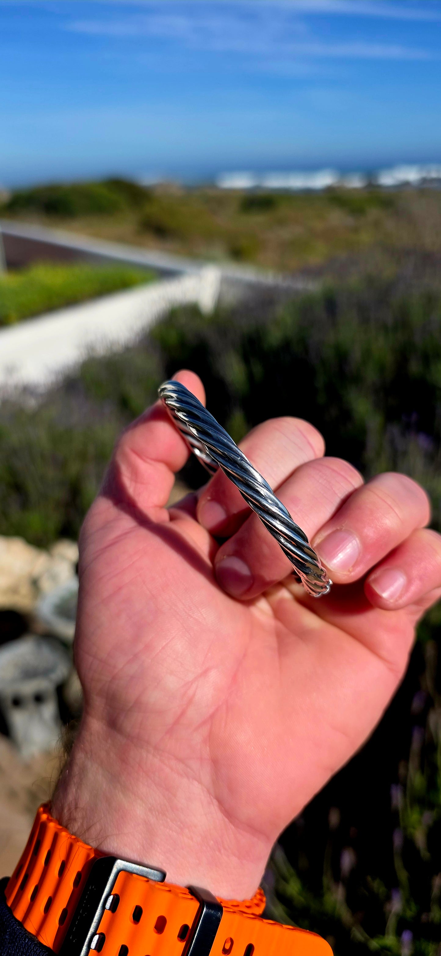 Fabulous and beautifully UNISEX! This vintage Italian bangle is crafted in sterling silver with a classic oval profile and a wonderful twisted tubular design.