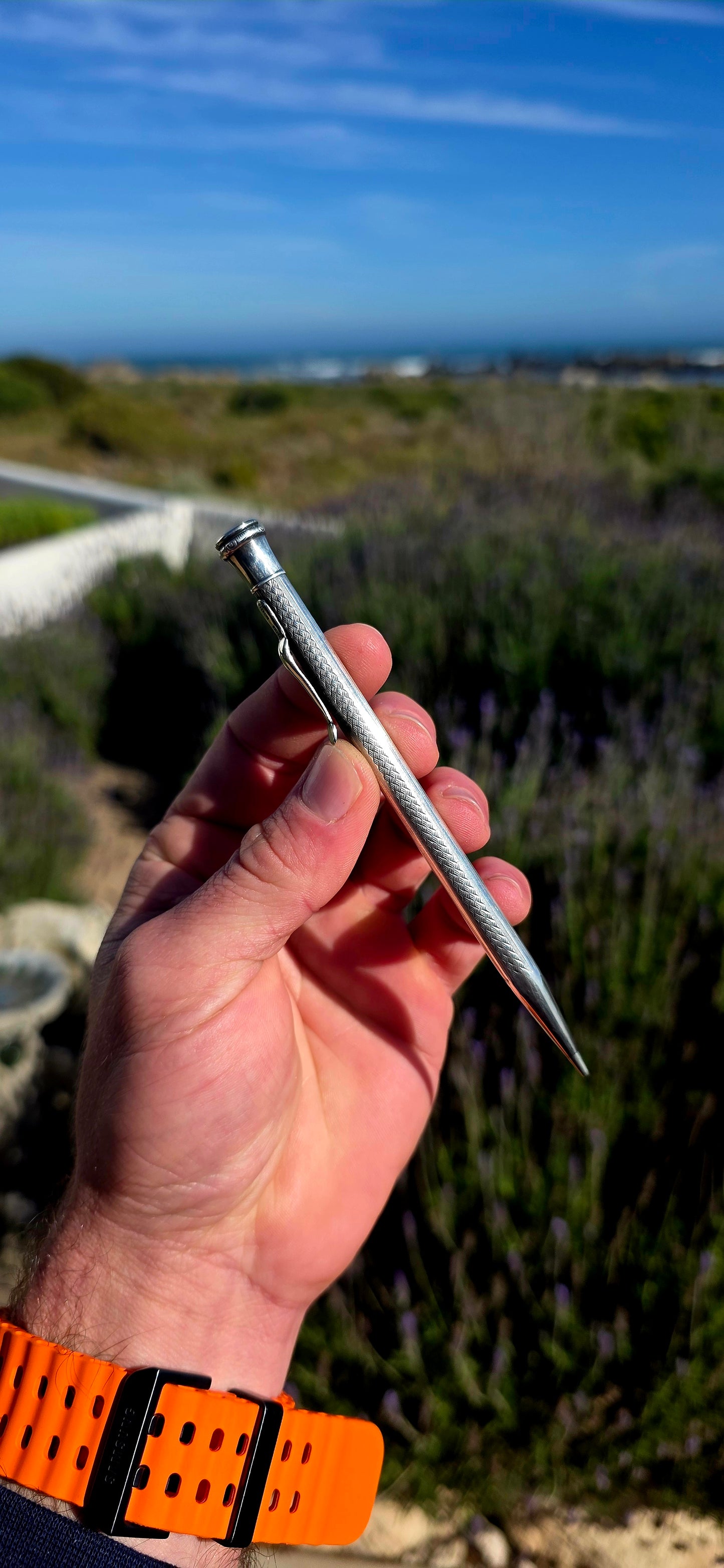 Dating to circa 1920s, this antique mechanical propelling pencil is crafted in solid sterling silver, with the slender body beautifully decorated in a fine engine-turned geometric pattern.