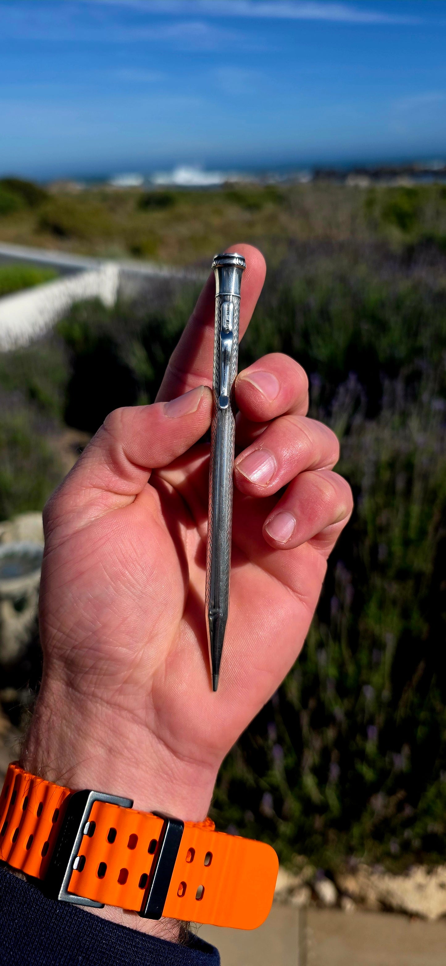 Dating to circa 1920s, this antique mechanical propelling pencil is crafted in solid sterling silver, with the slender body beautifully decorated in a fine engine-turned geometric pattern.