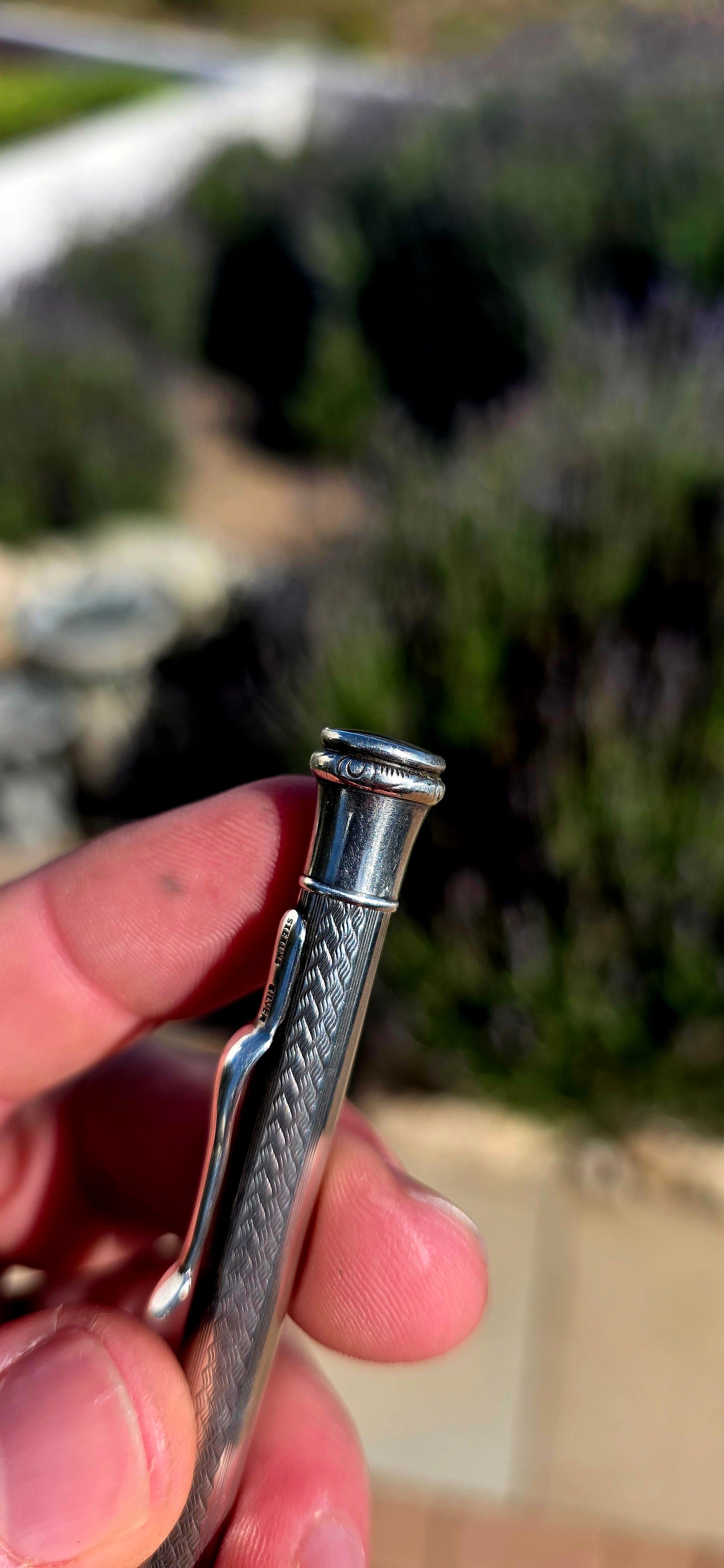 Dating to circa 1920s, this antique mechanical propelling pencil is crafted in solid sterling silver, with the slender body beautifully decorated in a fine engine-turned geometric pattern.
