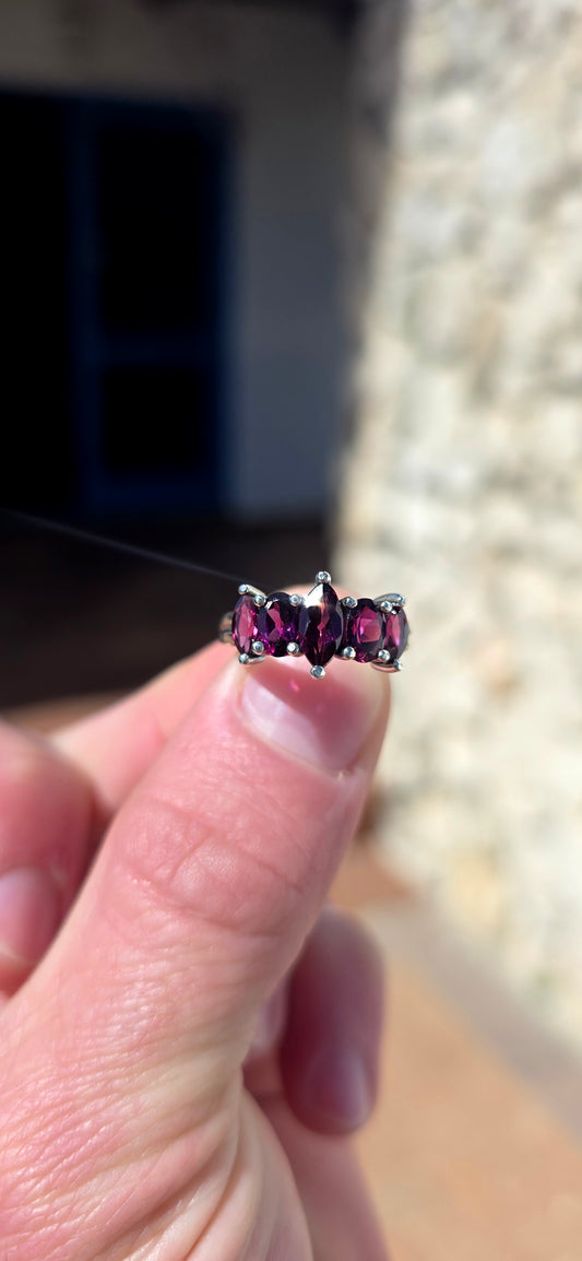 Rich, elegant and beautiful!! This sterling silver half-eternity style ring showcases a gorgeous graduated arrangement of five natural rhodolite garnets, each individually prong-set to maximise their colour and sparkle.