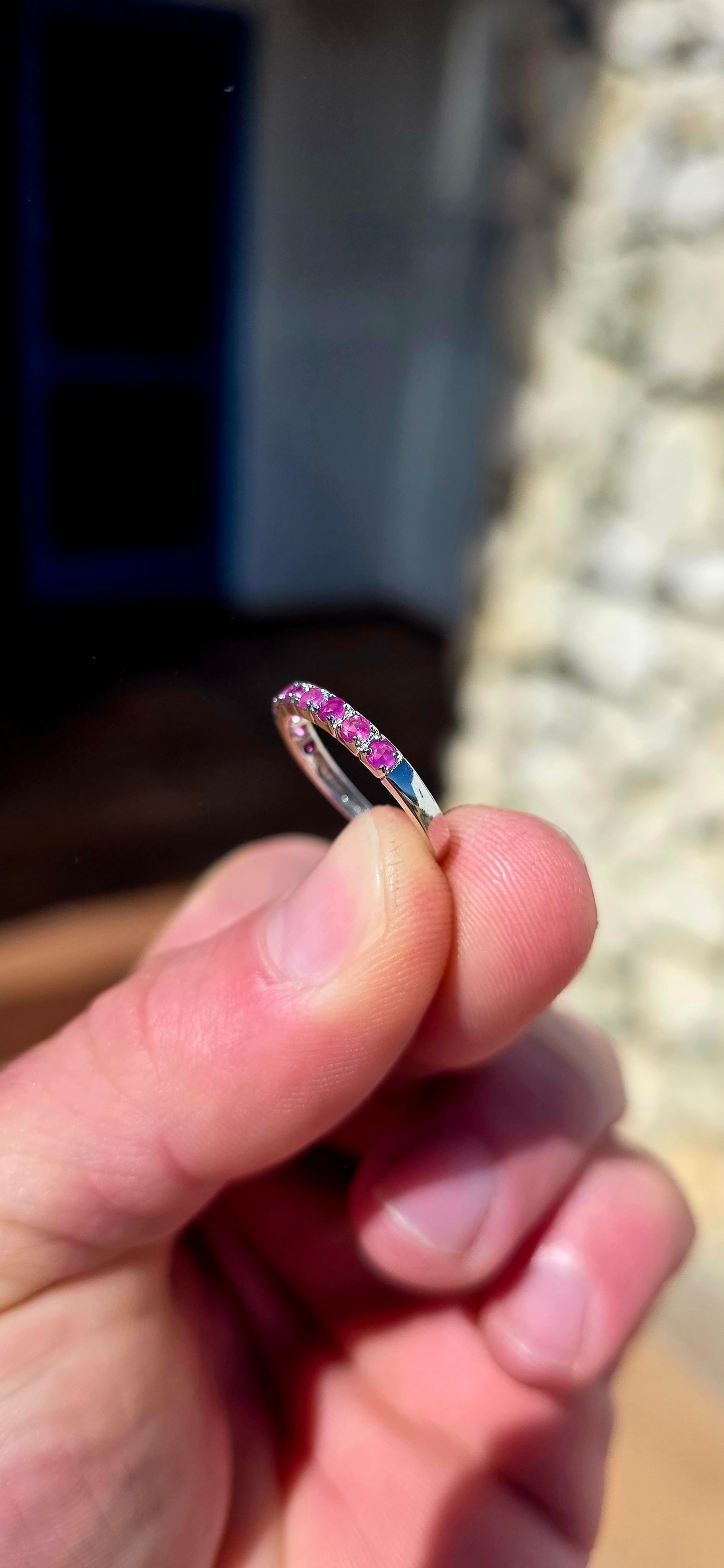 Delicate, feminine and made for stacking! This petite sterling silver half-eternity ring features a neat row of nine round-cut natural rubies, individually set across the front of the slender band.