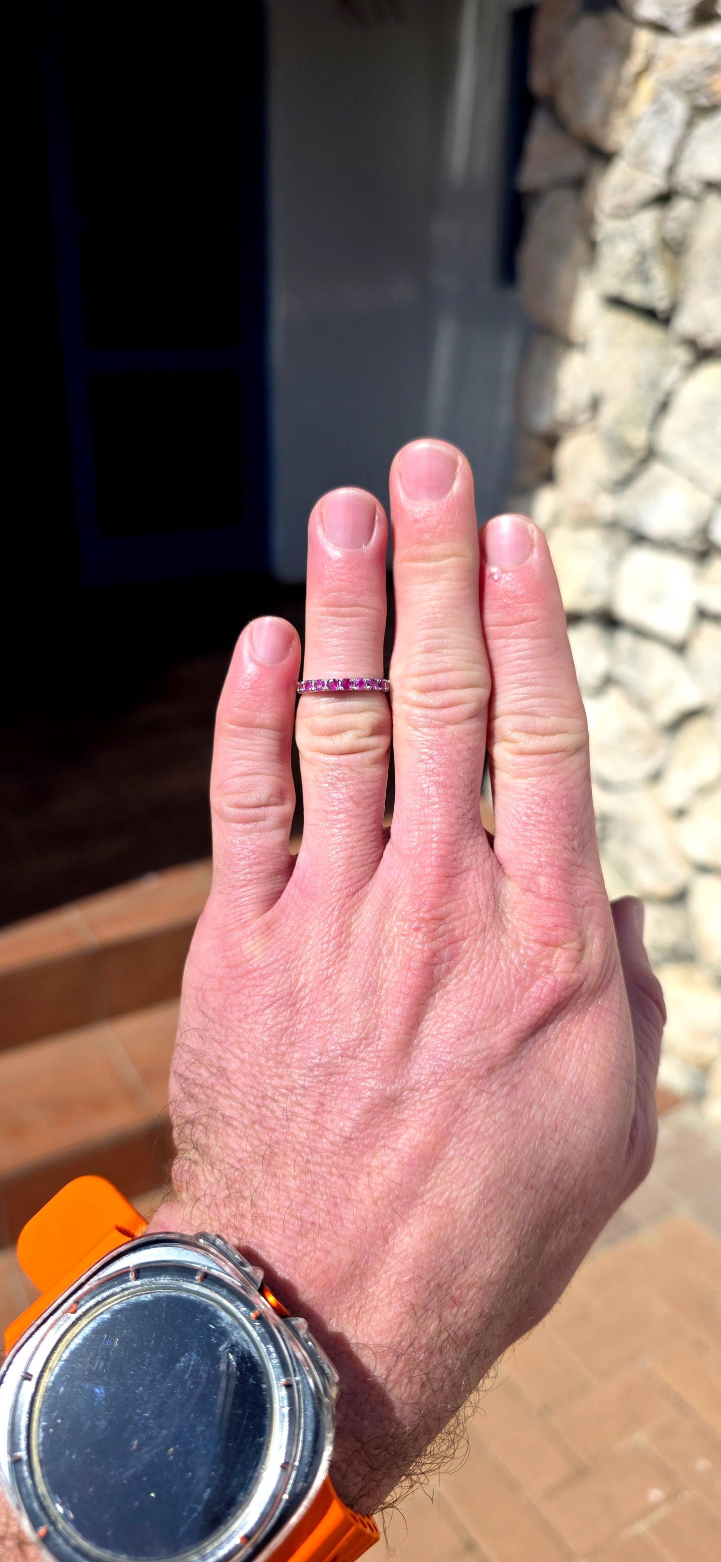 Delicate, feminine and made for stacking! This petite sterling silver half-eternity ring features a neat row of nine round-cut natural rubies, individually set across the front of the slender band.