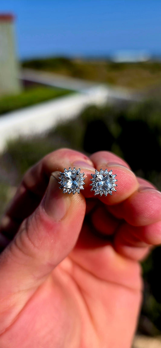 Classic sparkle with a fabulous vintage-inspired feel! These sterling silver halo stud earrings feature a beautifully faceted cushion-cut clear quartz at the centre of each earring, securely prong-set.