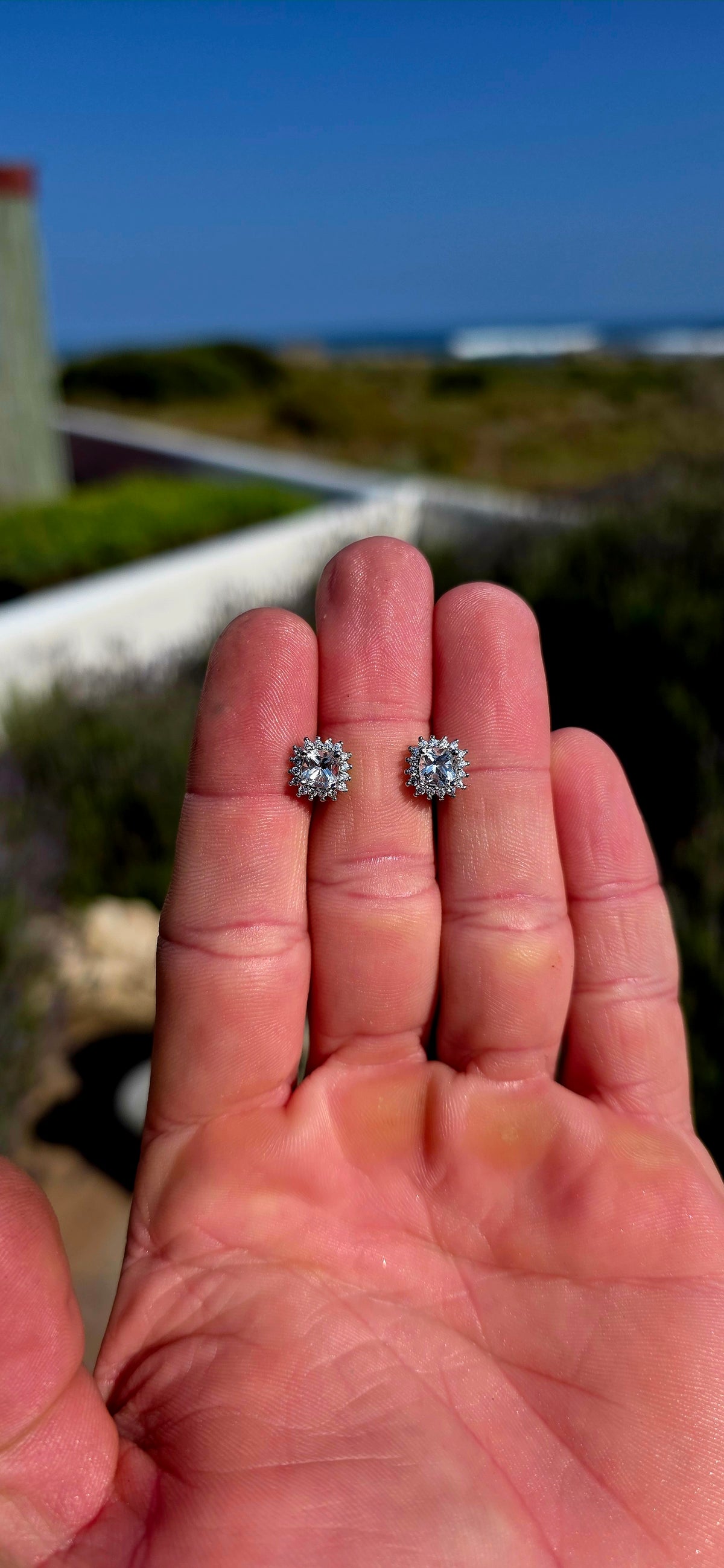 Classic sparkle with a fabulous vintage-inspired feel! These sterling silver halo stud earrings feature a beautifully faceted cushion-cut clear quartz at the centre of each earring, securely prong-set.