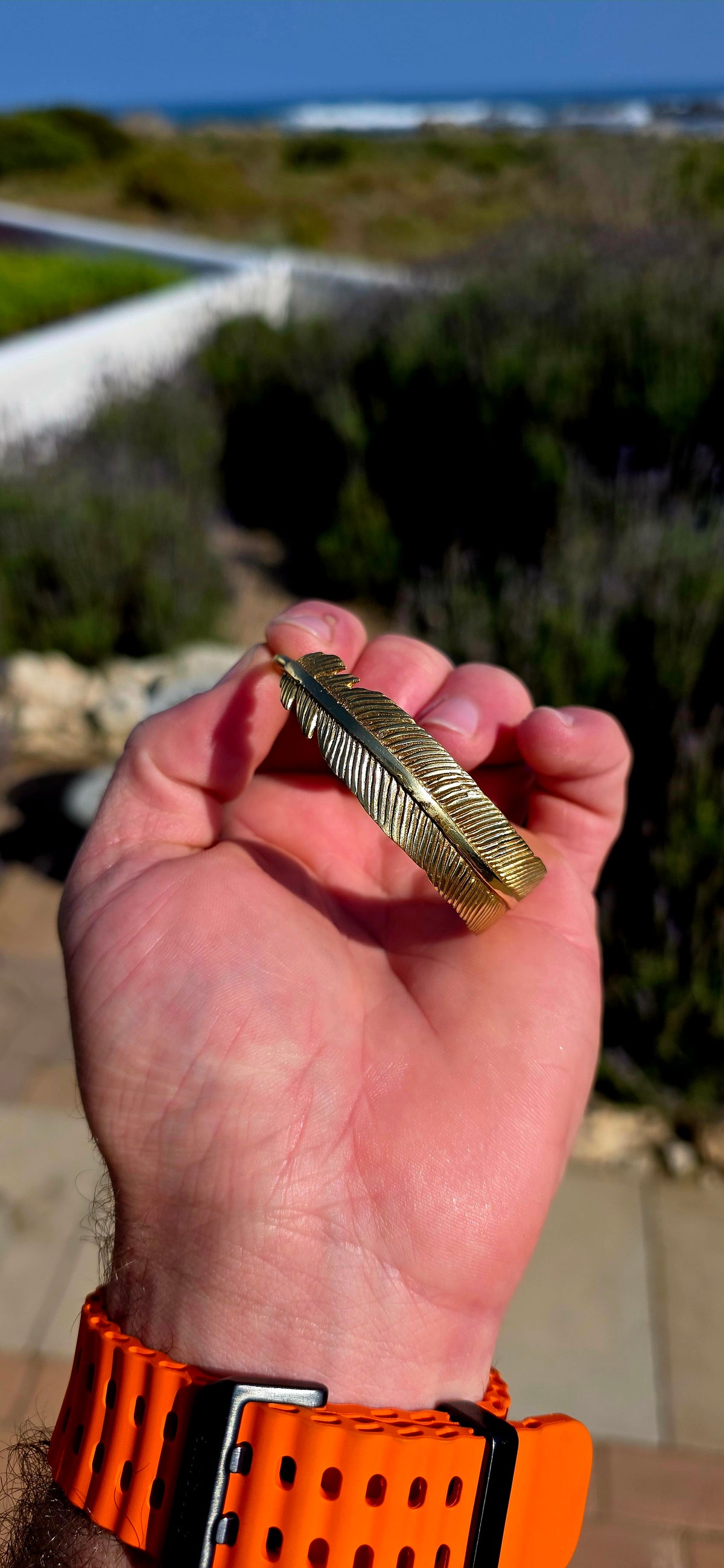 Bold, sculptural and beautifully UNISEX! This artisan-made solid brass open cuff bracelet takes the form of a magnificent feather wrapping gracefully around the wrist.