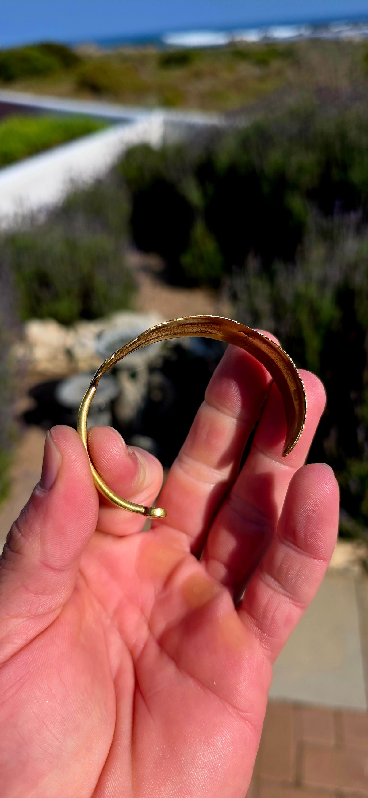 Bold, sculptural and beautifully UNISEX! This artisan-made solid brass open cuff bracelet takes the form of a magnificent feather wrapping gracefully around the wrist.