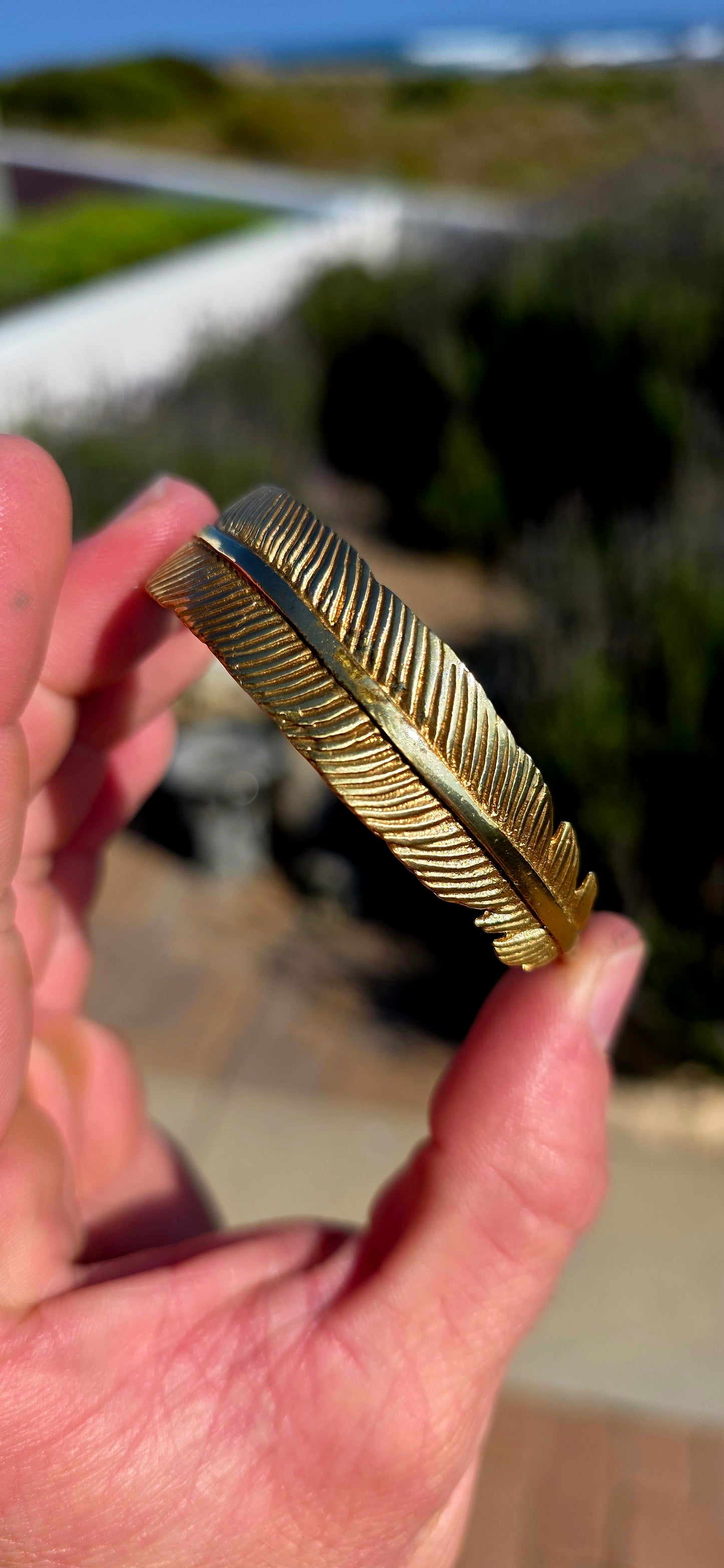Bold, sculptural and beautifully UNISEX! This artisan-made solid brass open cuff bracelet takes the form of a magnificent feather wrapping gracefully around the wrist.