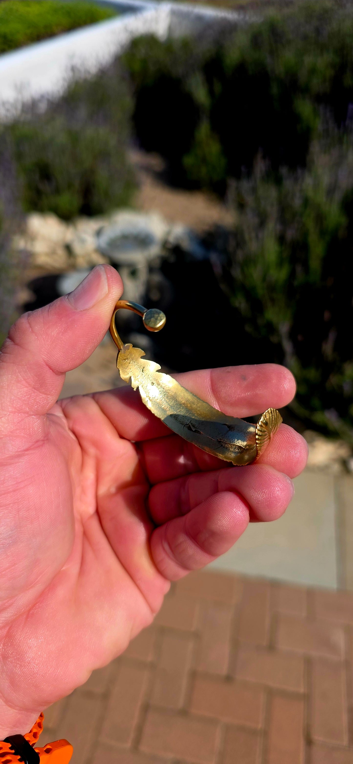 Bold, sculptural and beautifully UNISEX! This artisan-made solid brass open cuff bracelet takes the form of a magnificent feather wrapping gracefully around the wrist.