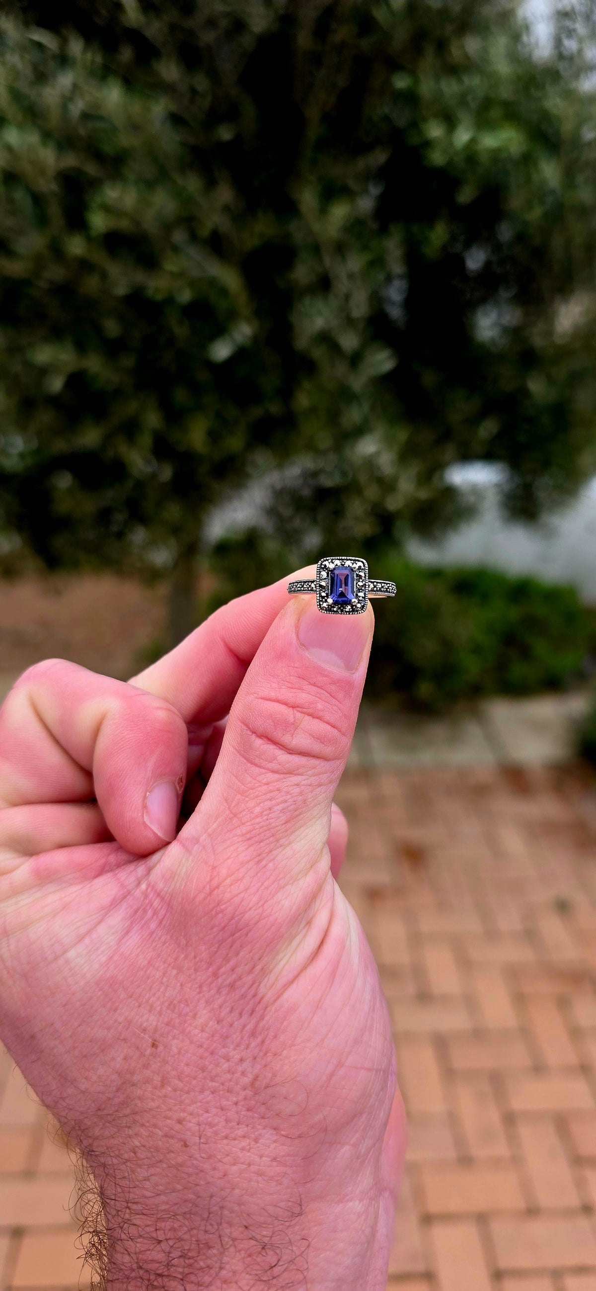 Crafted in solid sterling silver, this elegant solitaire ring centres around a beautifully emerald-cut iolite, raised within a classic four-prong setting
