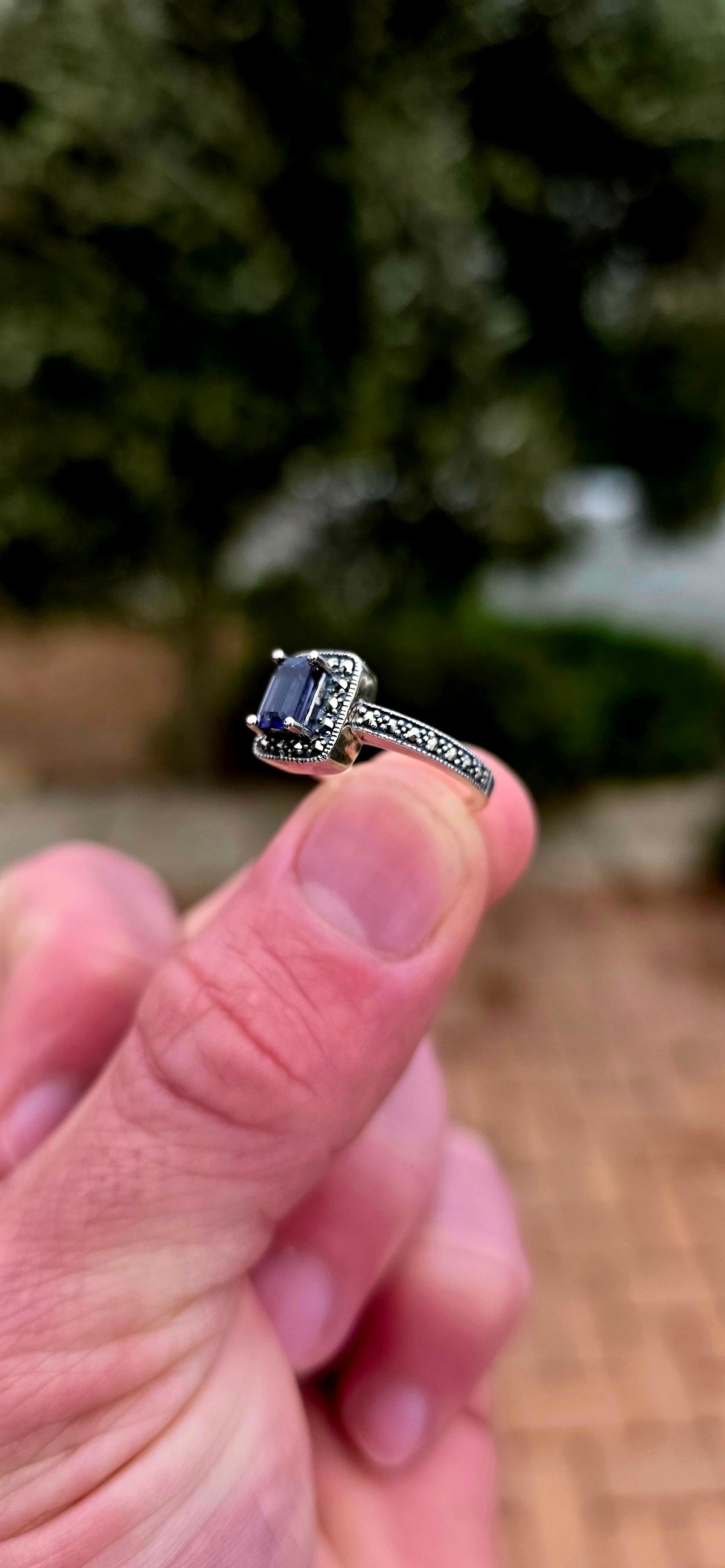 Crafted in solid sterling silver, this elegant solitaire ring centres around a beautifully emerald-cut iolite, raised within a classic four-prong setting