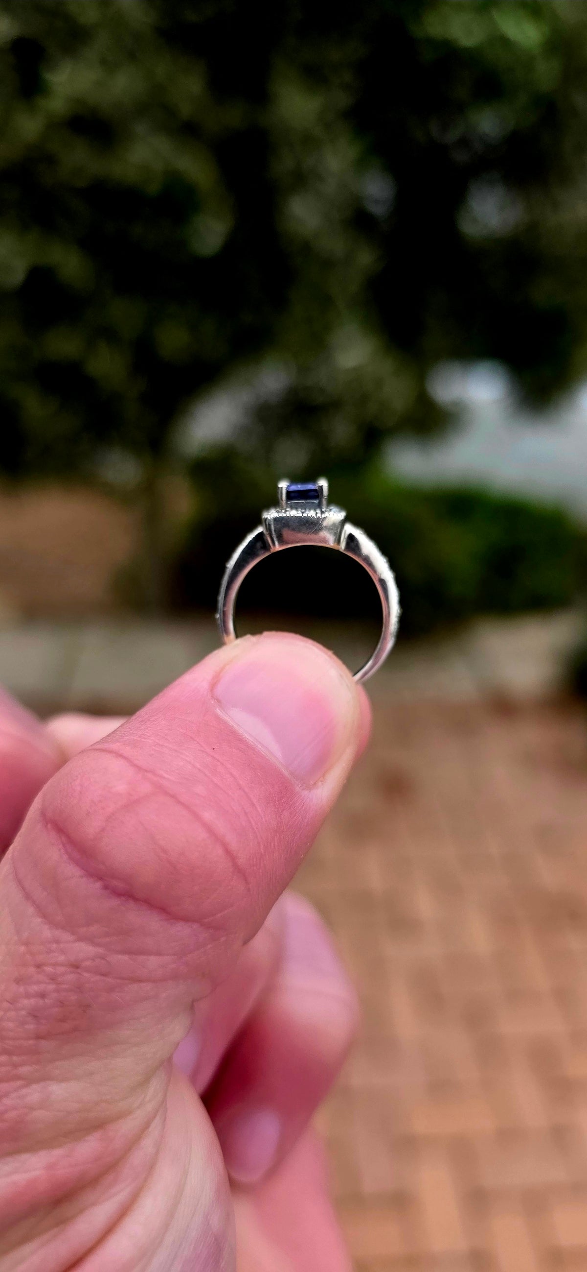 Crafted in solid sterling silver, this elegant solitaire ring centres around a beautifully emerald-cut iolite, raised within a classic four-prong setting