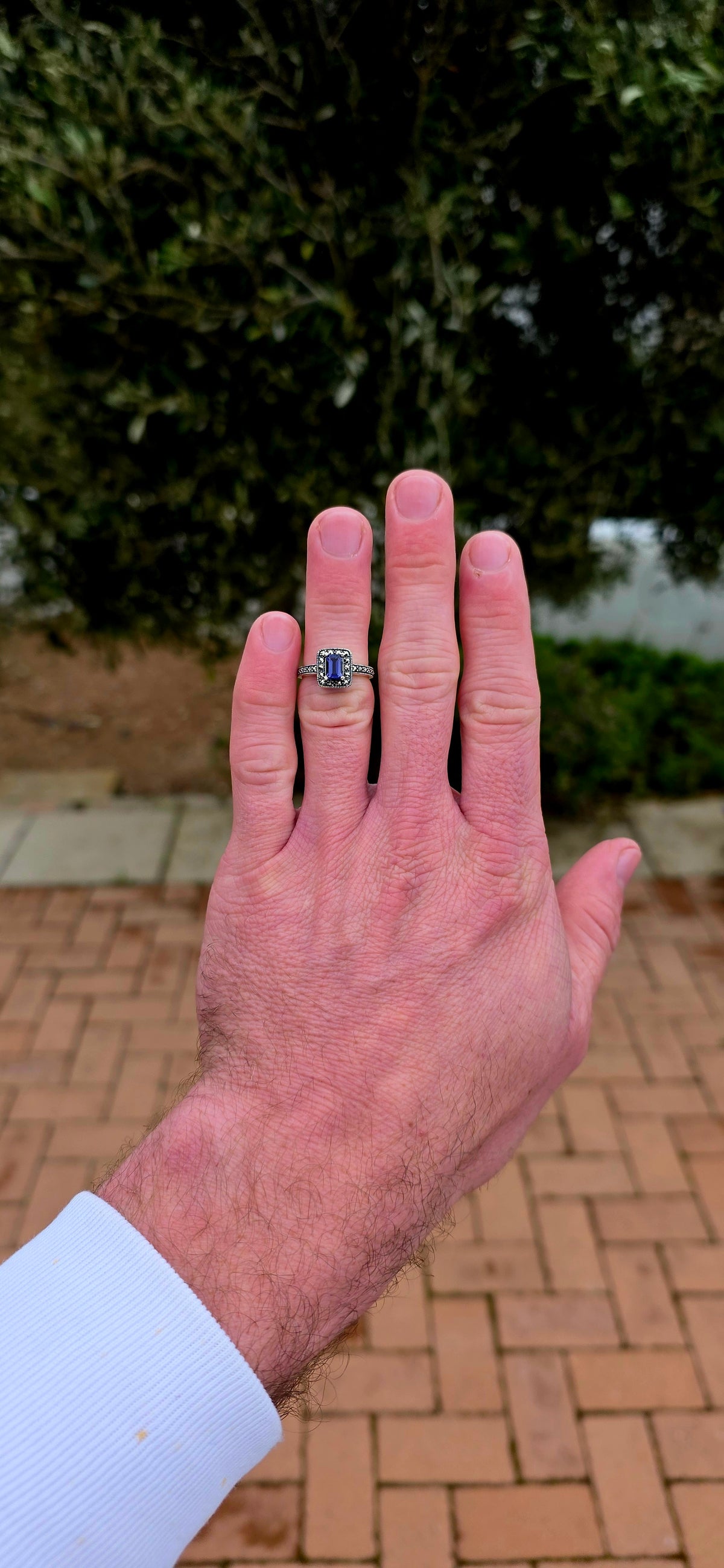 Crafted in solid sterling silver, this elegant solitaire ring centres around a beautifully emerald-cut iolite, raised within a classic four-prong setting