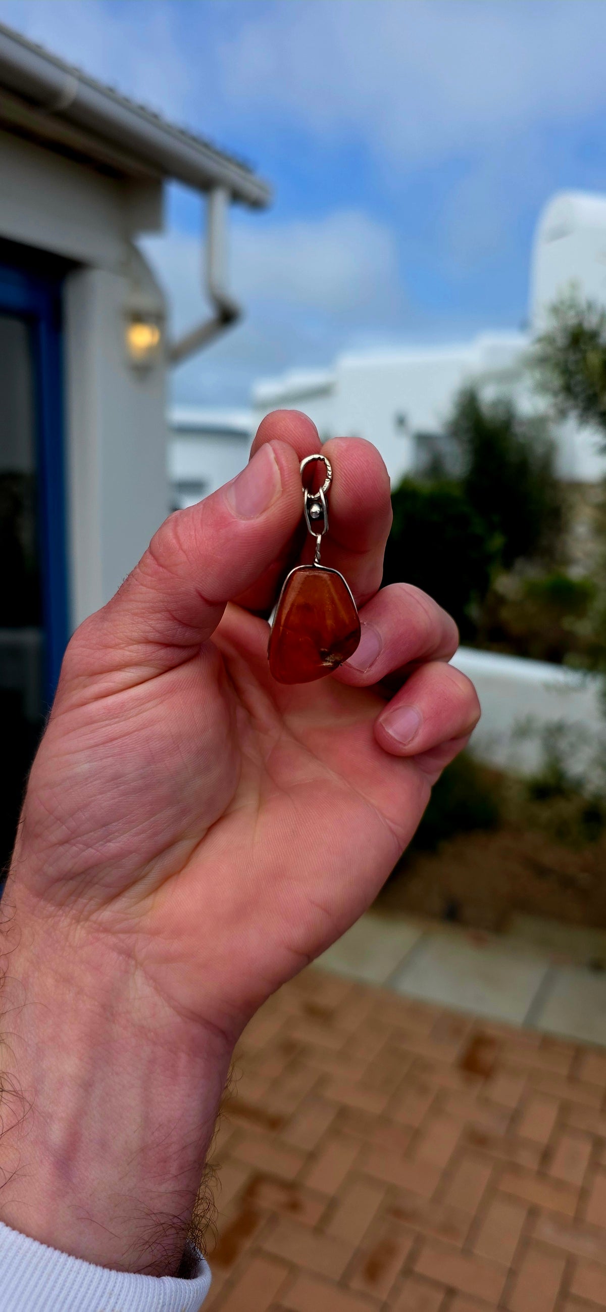 Ancient looking and absolutely gorgeous! This antique sterling silver pendant celebrates amber in its most beautifully organic form — irregular, earthy and completely individual.