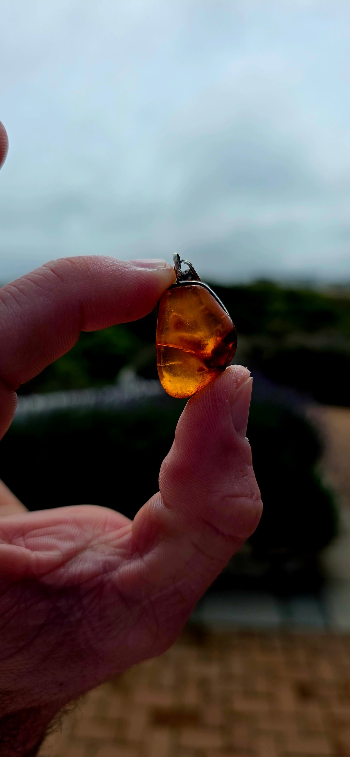 Ancient looking and absolutely gorgeous! This antique sterling silver pendant celebrates amber in its most beautifully organic form — irregular, earthy and completely individual.