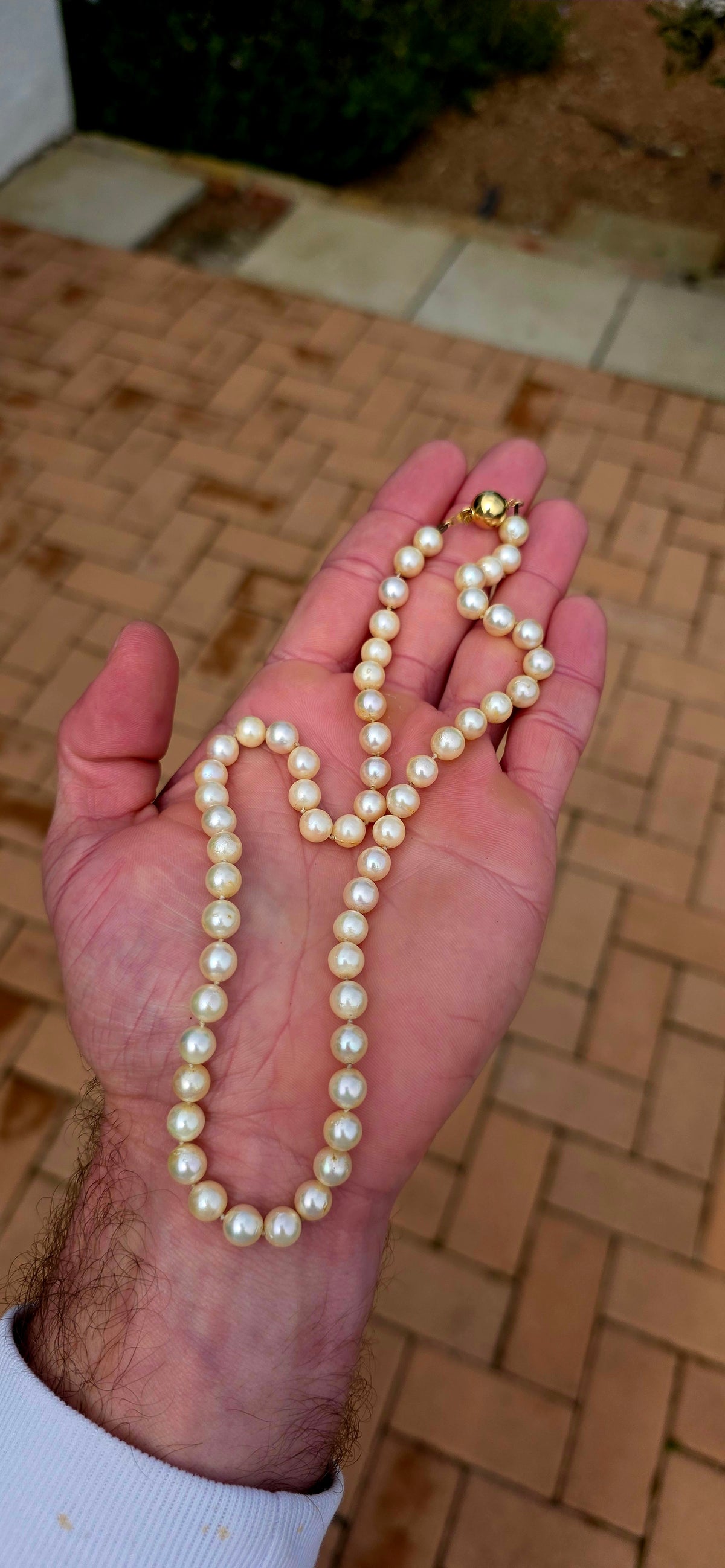 Beautifully timeless! Dating to the Art Deco era, this elegant necklace features a long single strand of wonderfully lustrous marine cultured pearls, displaying creamy ivory tones with that gorgeous soft glow only pearls can give.