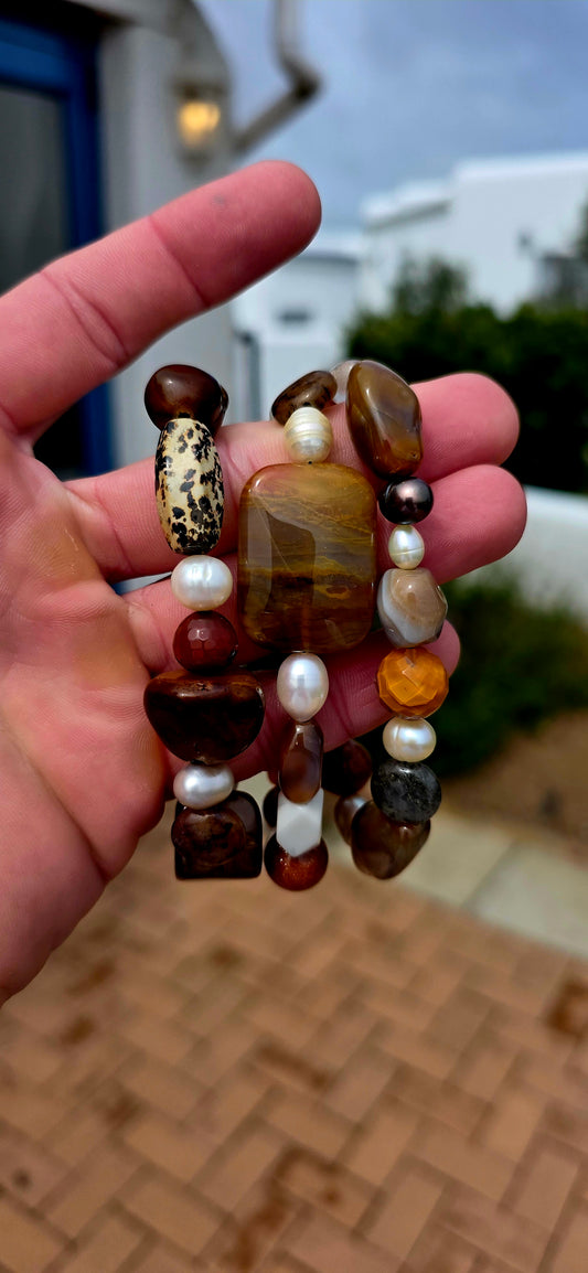 What an absolutely GORGEOUS earthy trio! The trio consists of three individual stretch bracelets, each strung with an eclectic mixture of natural gemstones and freshwater pearls in beautifully warm, organic tones.
