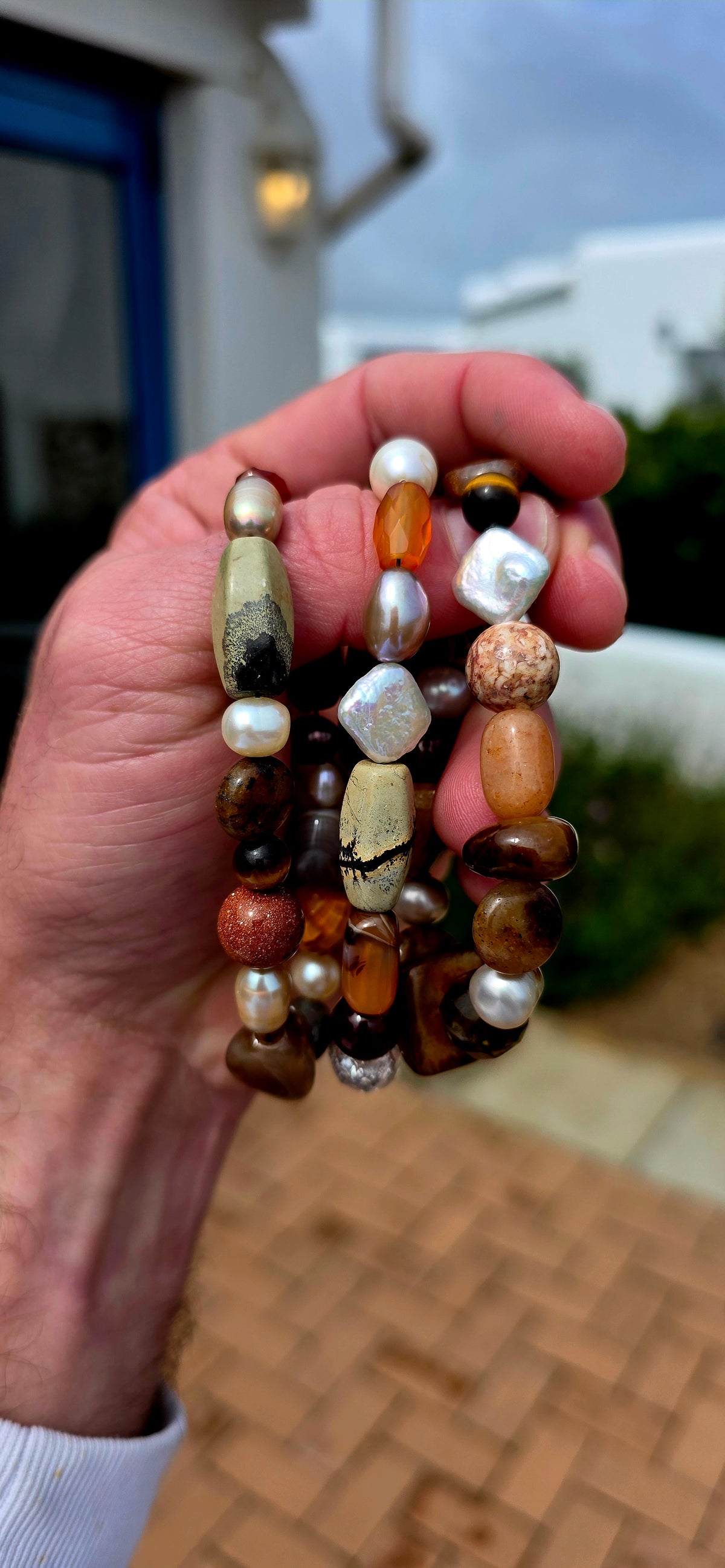 What an absolutely GORGEOUS earthy trio! The trio consists of three individual stretch bracelets, each strung with an eclectic mixture of natural gemstones and freshwater pearls in beautifully warm, organic tones.