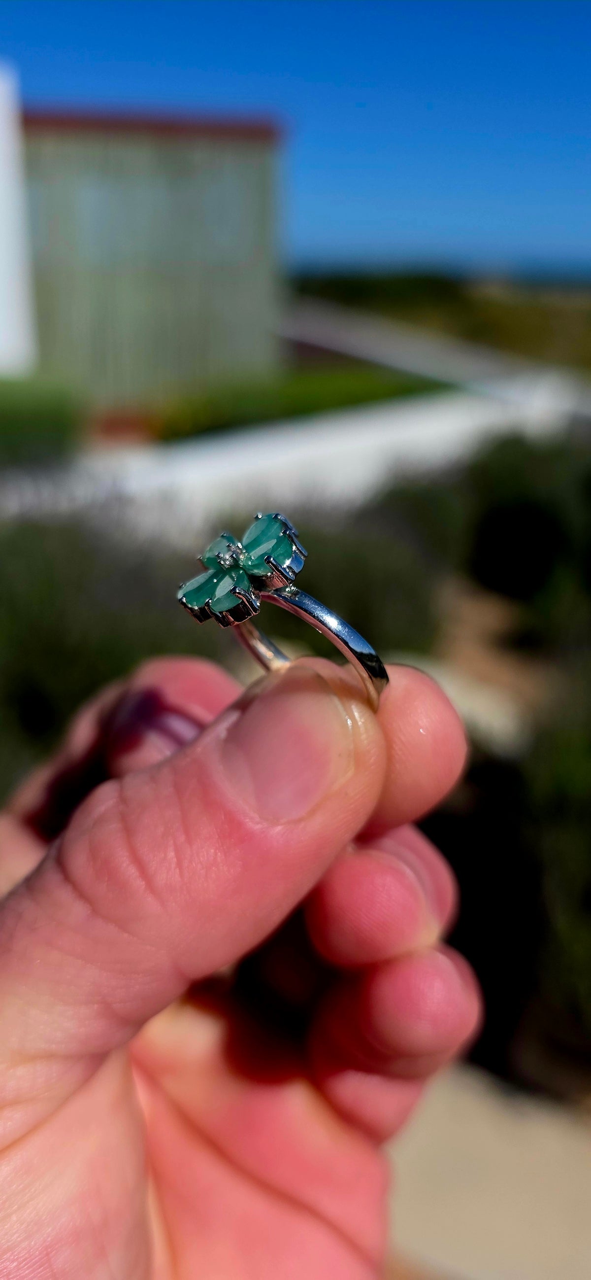 Feminine, magical and bursting with colour — this gorgeous sterling silver ring is like a little emerald flower blooming across the finger!