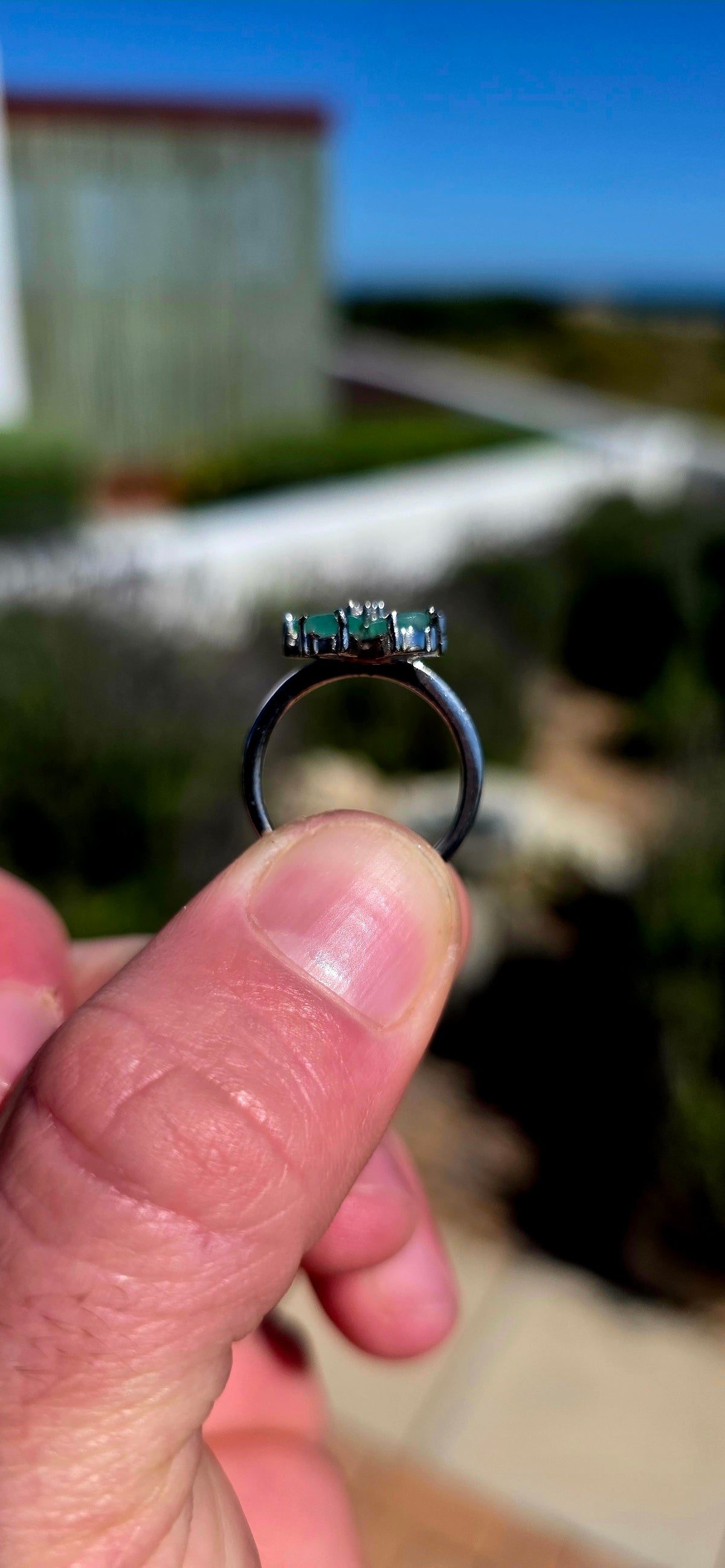 Feminine, magical and bursting with colour — this gorgeous sterling silver ring is like a little emerald flower blooming across the finger!