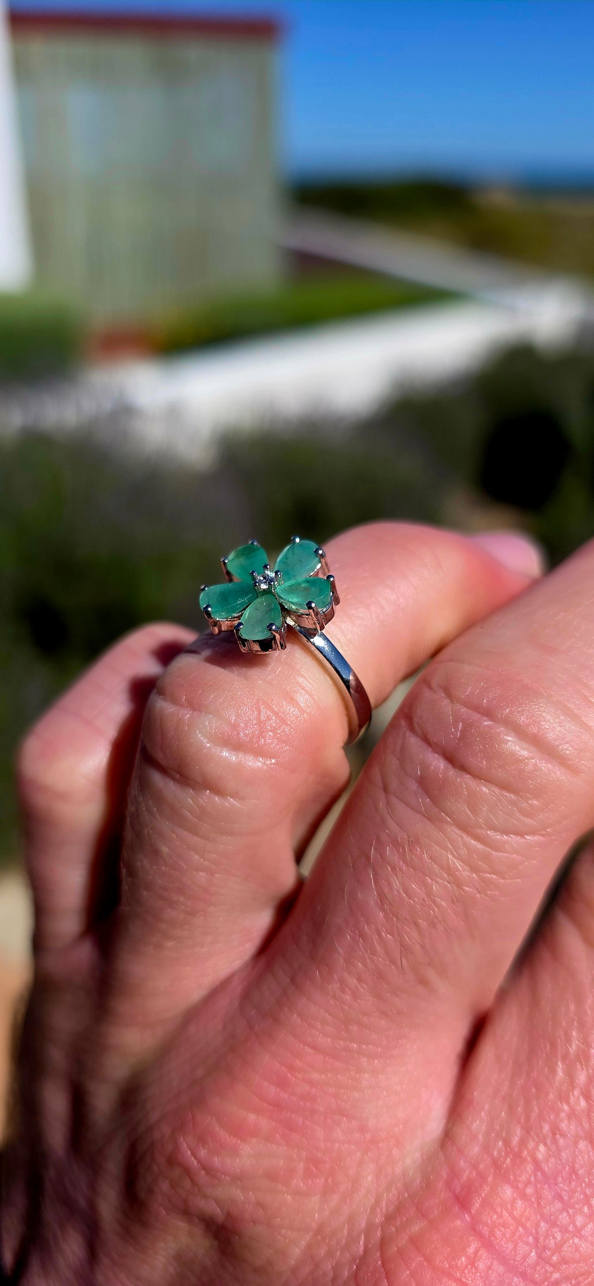 Feminine, magical and bursting with colour — this gorgeous sterling silver ring is like a little emerald flower blooming across the finger!
