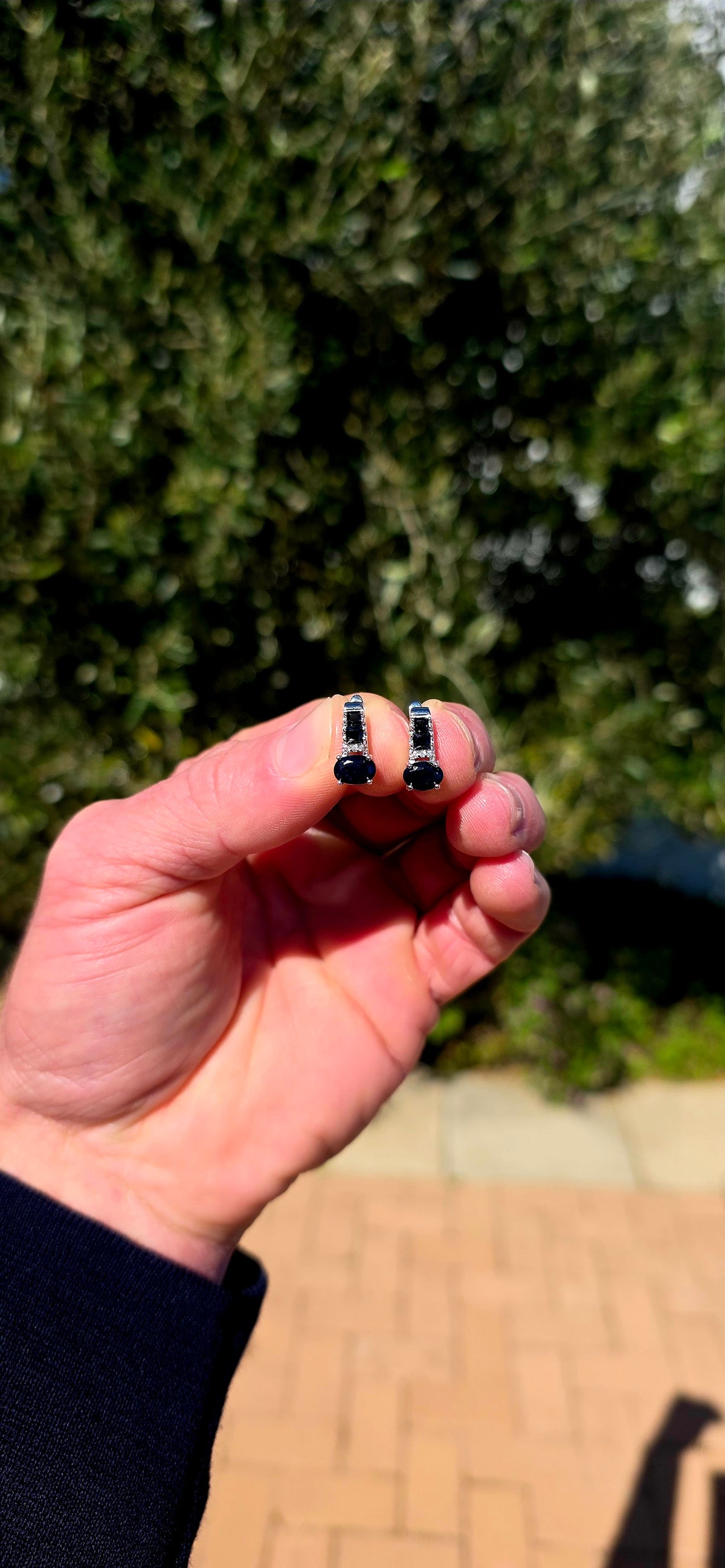 These elegant sterling silver earrings carry through a gorgeous combination of deep blue sapphires and crisp white sparkle.