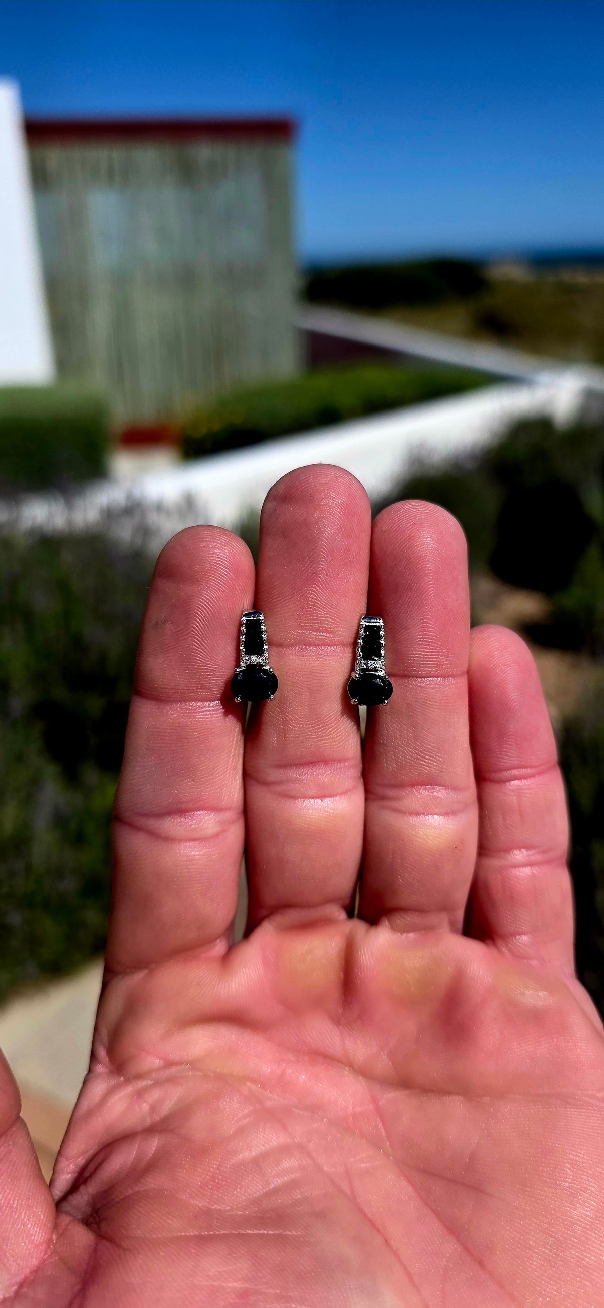 These elegant sterling silver earrings carry through a gorgeous combination of deep blue sapphires and crisp white sparkle.